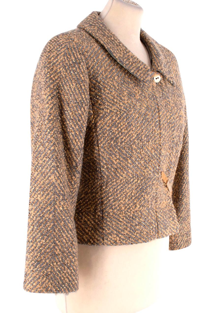 Chanel Grey & Gold Herringbone Tweed Jacket
 

 - Classic cut, slighty cropped jacket crafted from Herringbone tweed in a warm mid-grey and rich gold weave, with a subtle metallic thread running through
 - Peter Pan collar, bracelet length sleeves 
