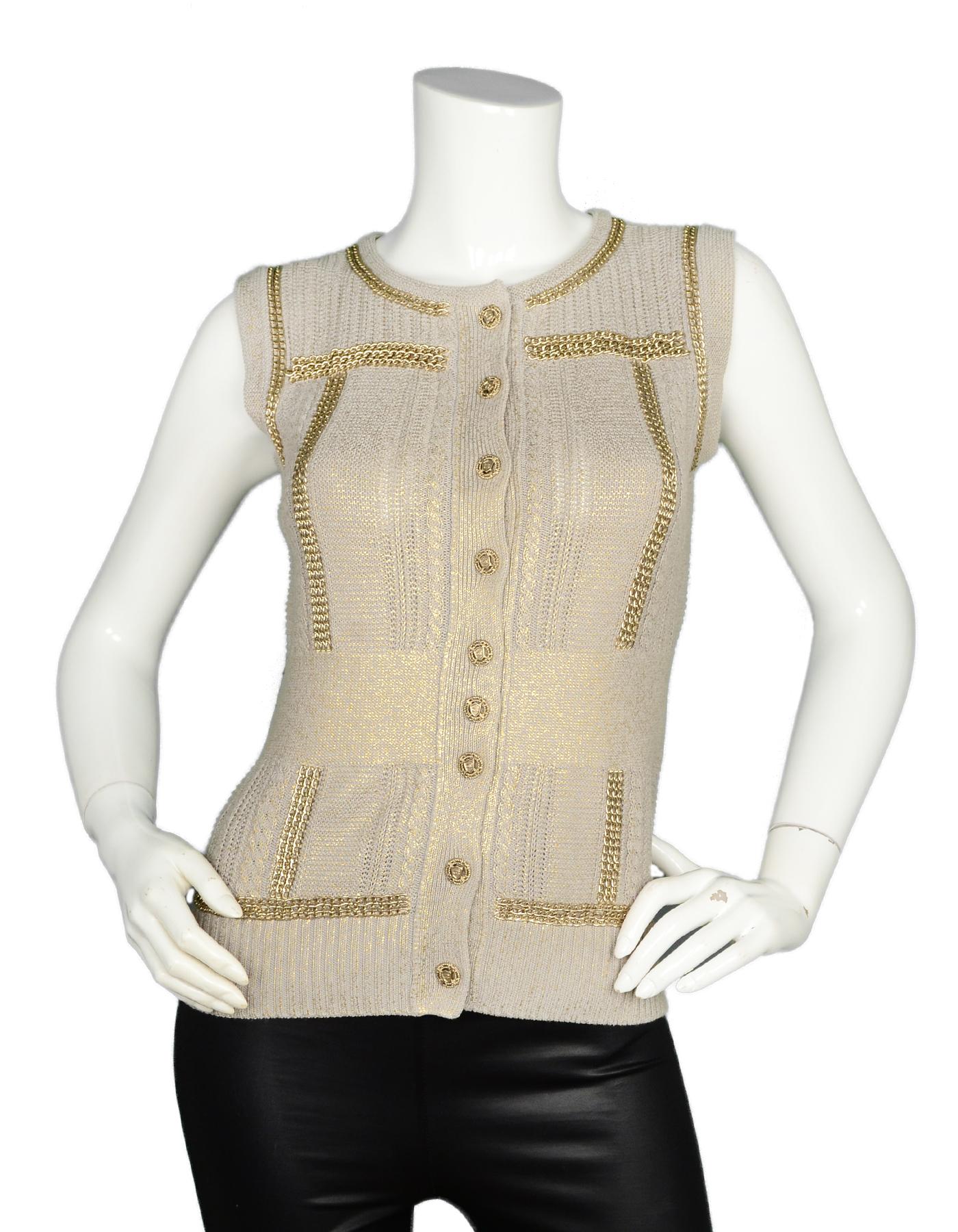 Chanel Taupe Grey/Gold Metallic Knit Vest W/ Chain Detailing & CC Shield Buttons Sz 38

Made In: Italy
Year of Production: 2008
Color: Taupe grey and gold
Materials: 56% rayon, 44% cotton, metal
Opening/Closure: CC shield button down front
Overall