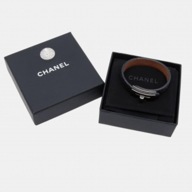 Chanel's loved Mademoiselle lock is chosen as the highlight of this simple bracelet. The central motif is presented in gunmetal-tone hardware and held by a snakeskin leather bracelet.