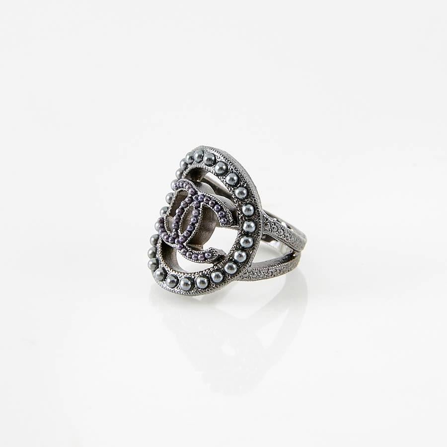 Never worn lovely Chanel ring with the famous CC symbol made of faux Grey Pearls. With its stamp 