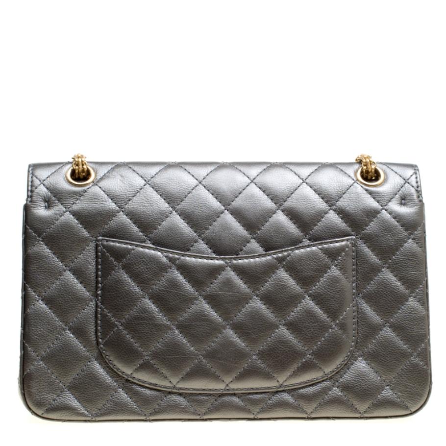 Chanel's Flap Bags are iconic and monumental in the history of fashion. This Reissue 2.55 Classic 226 is a buy that is worth every bit of your splurge. Exquisitely crafted from grey leather, it bears their signature quilt pattern and the iconic