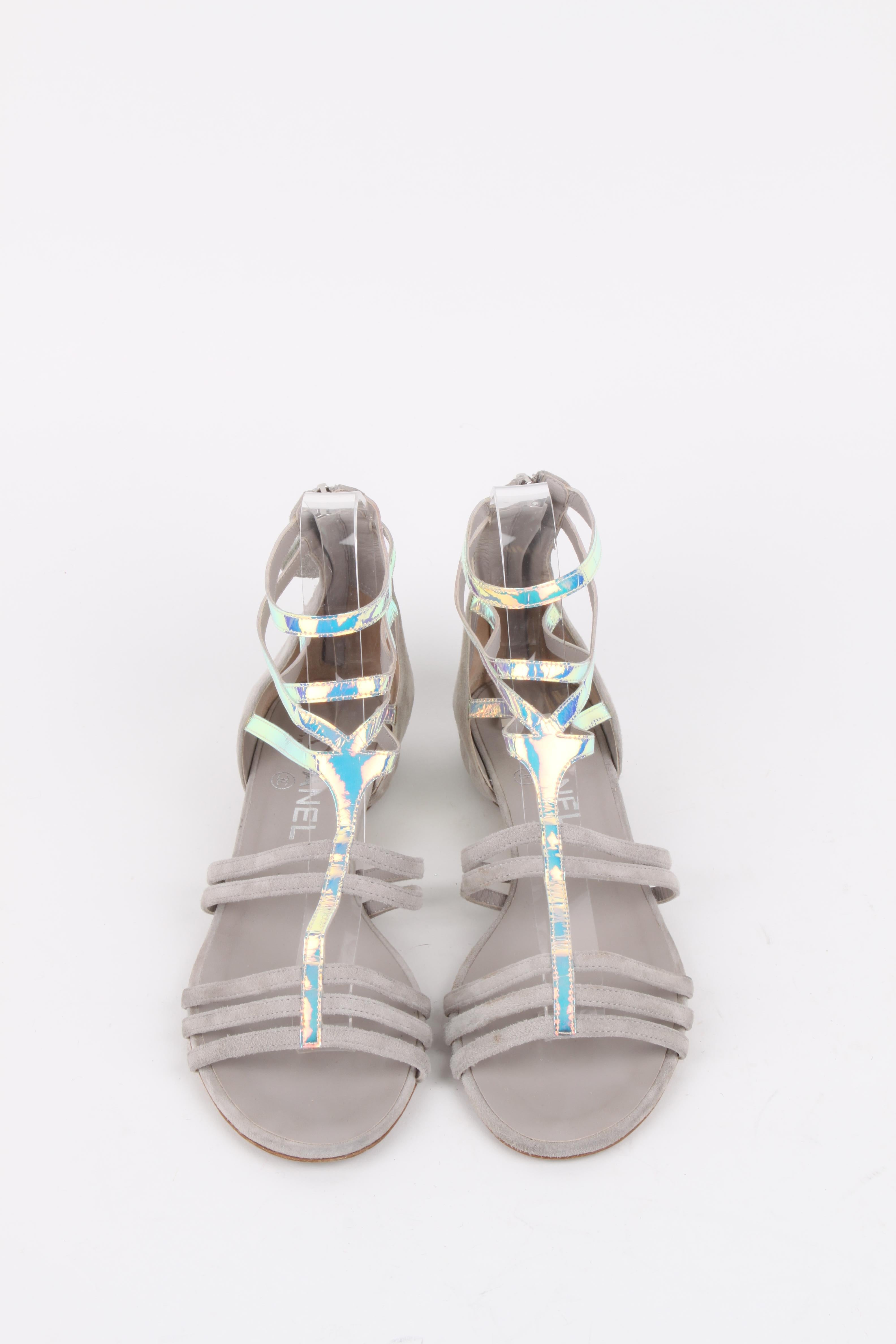 Chanel Grey Silver-Iridescent Gladiator Sandals.
From the house of Chanel comes this pair of silver-iridescent gladiator sandals that are simply splendid. They've been crafted from leather and styled with full back zippers and little ribbed motifs