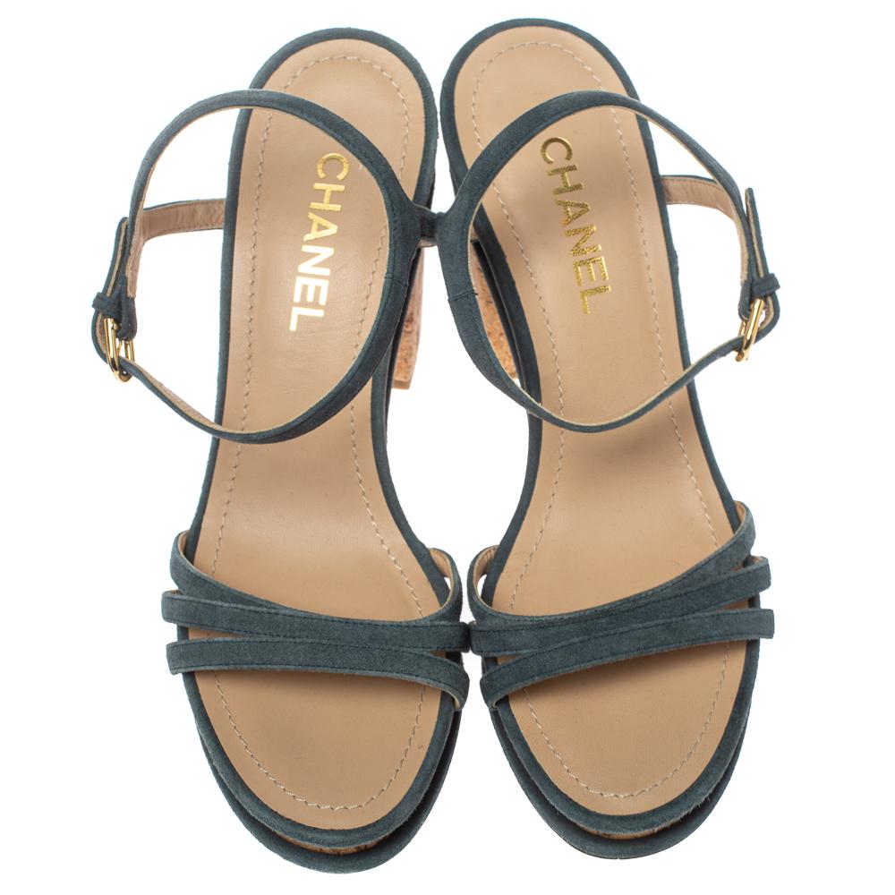 Flaunt these fabulous sandals from Chanel as step out in style. These sandals are crafted from suede and feature cork platforms as well as block heels. They carry thin vamp straps and ankle straps with buckle fastenings. These grey sandals are