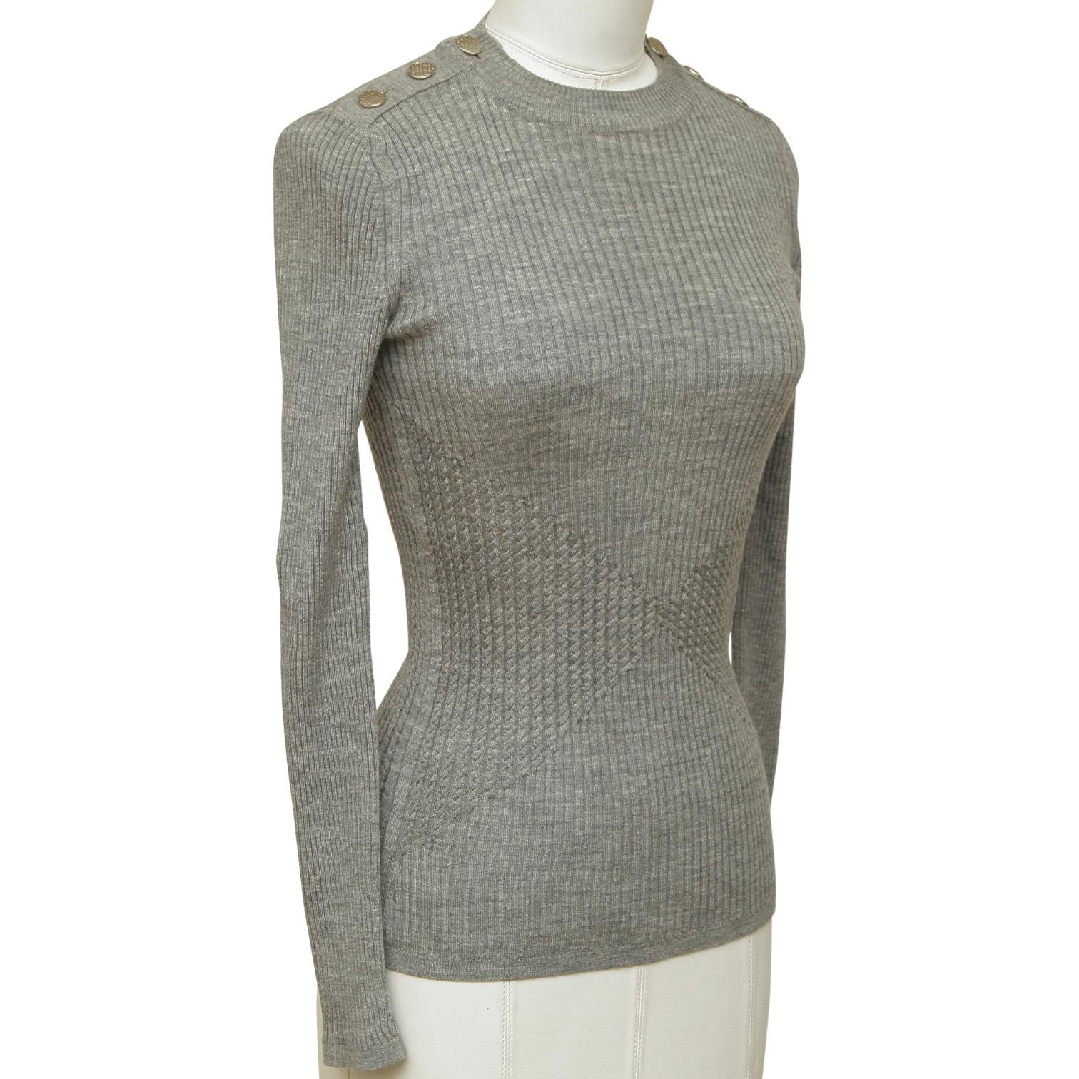 GUARANTEED AUTHENTIC CHANEL 2016 GREY LONG SLEEVE SWEATER

Design:
- Versatile long sleeve ribbed pattern knit top in a grey color.
- Crew neck.
- 3 silver buttons on each shoulder.
- Slip on.

Material: 90% Wool, 10% Cashmere

Size: