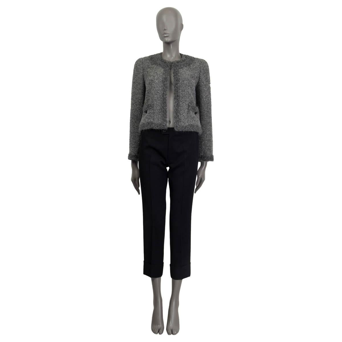 100% authentic Chanel Fall/Winter 1998 blazer in gray and charcoal wool (50%) and alpaka (50%). Features padded shoulders, knit details at the neck, cuffs and the 'CC' buttoned front pockets. Opens with one hook on the front. Sleeves lined in gray