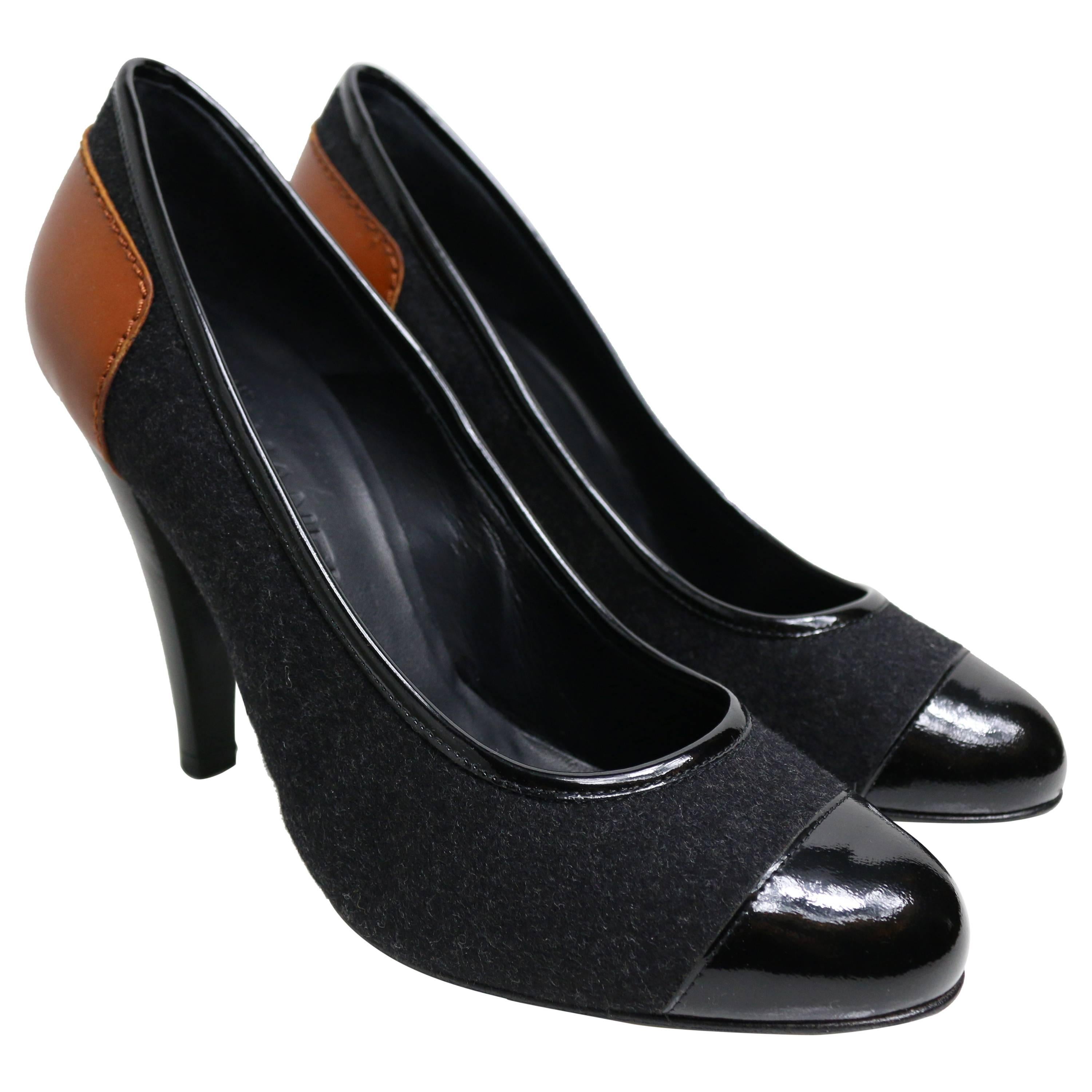 - Chanel bi-colour black patent leather/grey wool pumps with written 
