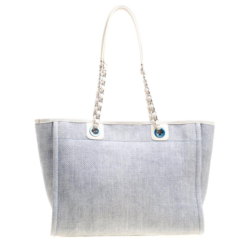 This Deauville tote from Chanel is crafted from raffia, leather and fabric in a lovely woven design and detailed with signature lettering. It has a spacious fabric interior and it is held by two interlinked chain handles. It is ideal for daily