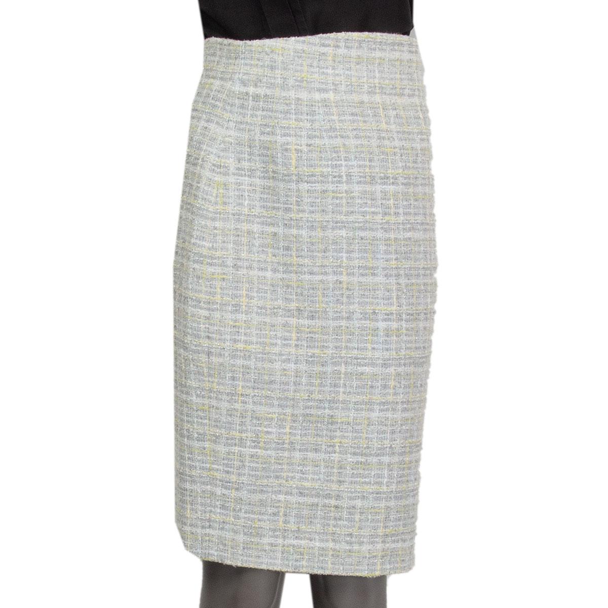 100% authentic Chanel boucle pencil skirt in light grey, white, lime cotton (56%), wool (19%), rayon (18%), nylon (6%) and polyester (1%). Closes with three hooks and a concealed zipper on the back and with a slit in the back. Lined in light grey