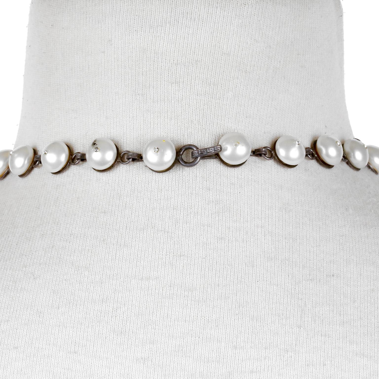 This very early Chanel Gripoix and Pearl Bib Necklace is in excellent vintage condition.  It is a one of a kind highly collectible piece designed by Coco herself from the Diana Vreeland estate sale.  Faux pearl choker with red and green dripping