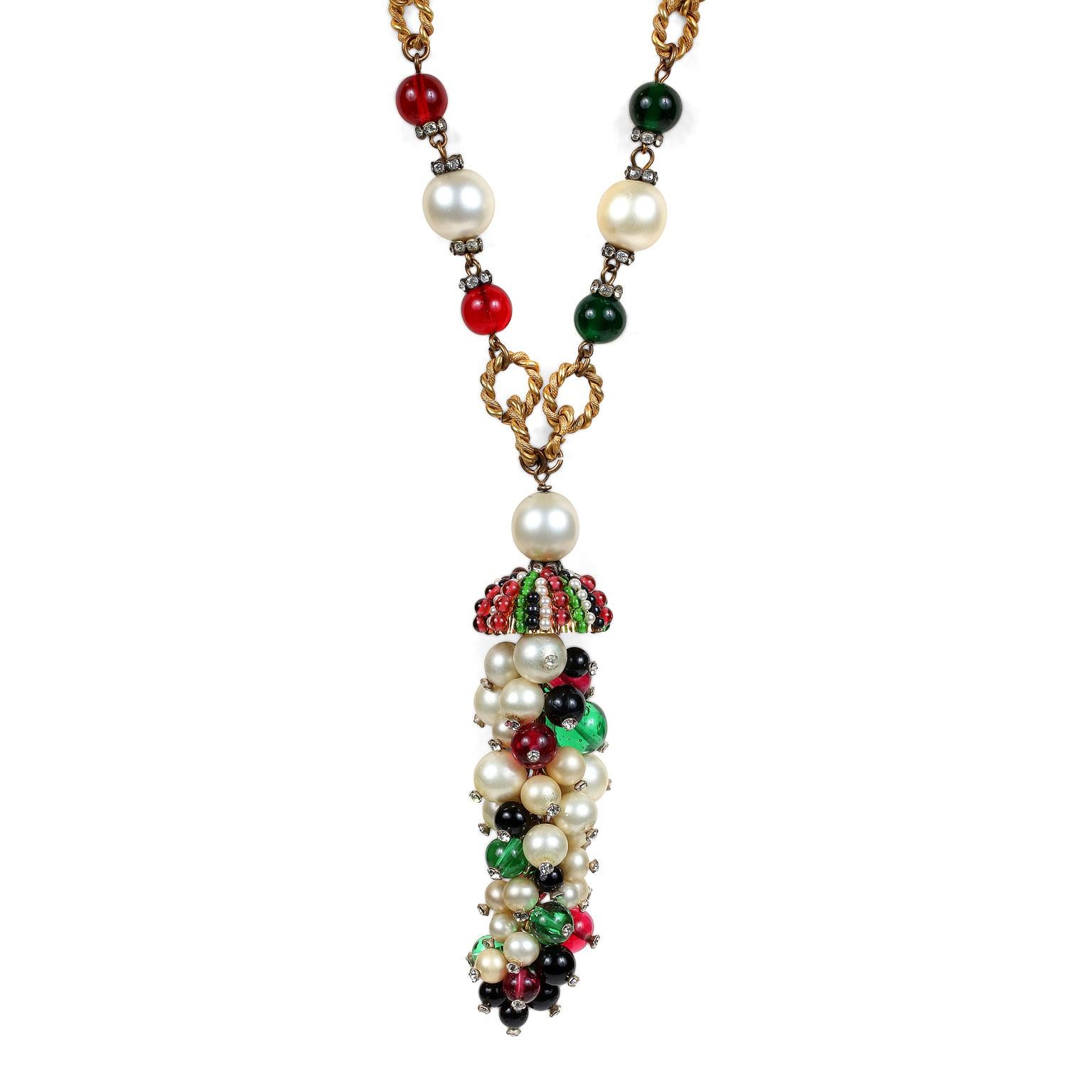 This authentic Chanel Gripoix and Pearl Domed Pendant Necklace is in excellent vintage condition from the 1950’s.  Red and green Gripoix glass beads and faux pearls are situated on a gold tone twisted link chain.  Stunning domed pendant cluster of
