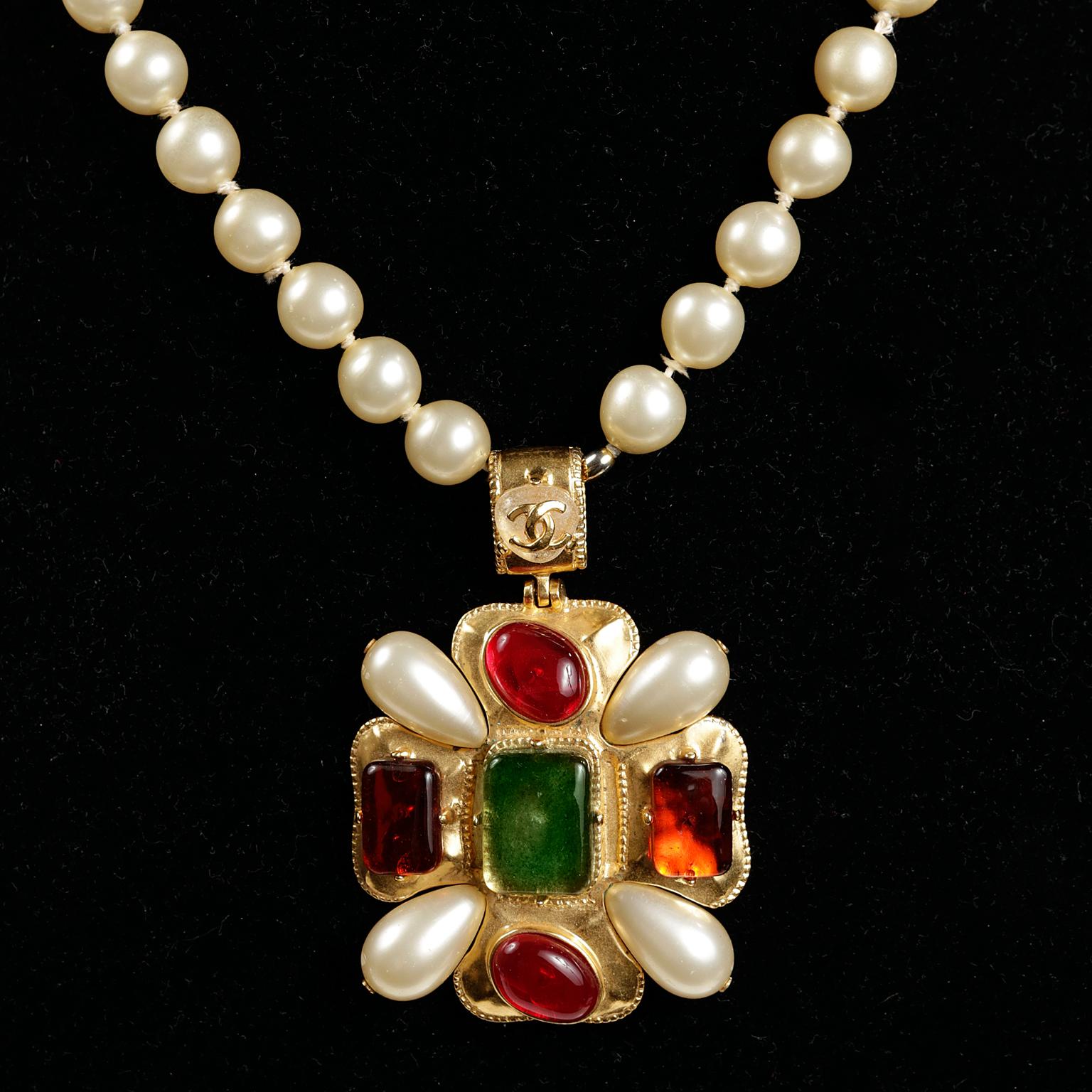 Chanel Gripoix and Pearl Necklace- excellent condition.  A beautiful and collectible piece from the Fall 1997 collection.
Large gold medallion with Gripoix stones in green, orange and red are anchored by faux pearls.  Dangles beautifully from a faux