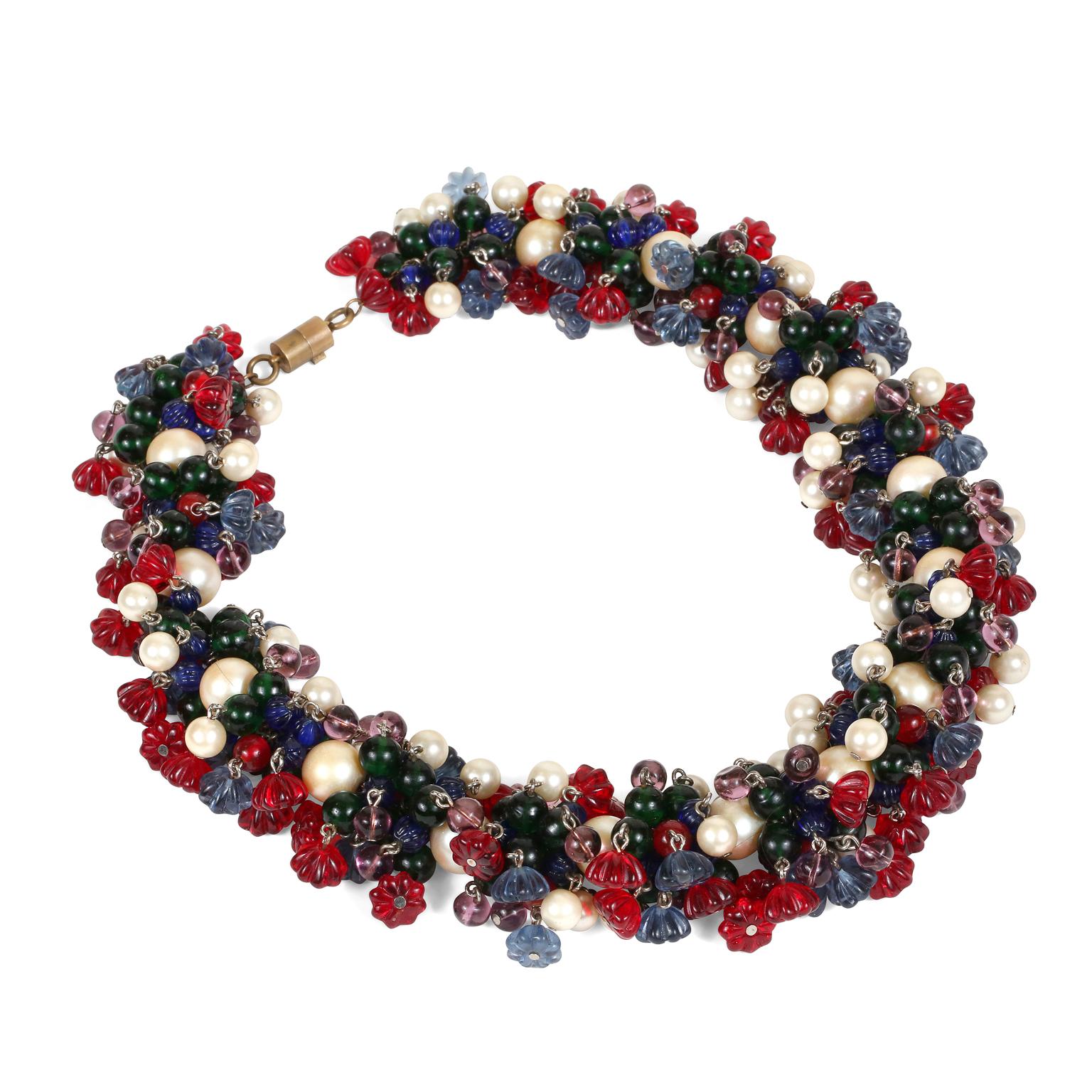 This authentic Chanel Gripoix and Pearl Tutti Frutti Necklace is in exceptionally good early vintage condition.  Red, blue, green and purple Gripoix glass beads and flowers are clustered together in this stunning necklace.  Interspersed with faux