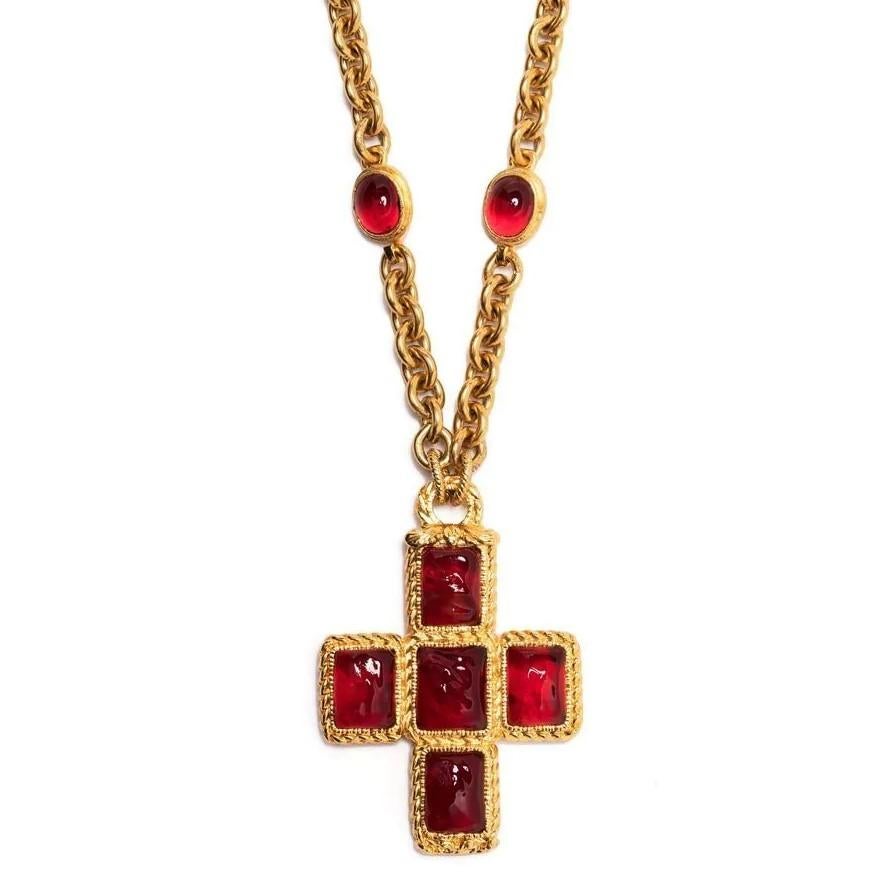 A Chanel Gripoix piece, this bold necklace displays a large gold-toned cross motif decorated with red cabochons hanging from a chunky gold chain. Secure using a hook fastening, this statement piece will uplift any outfit. Layer this 'XL' style with