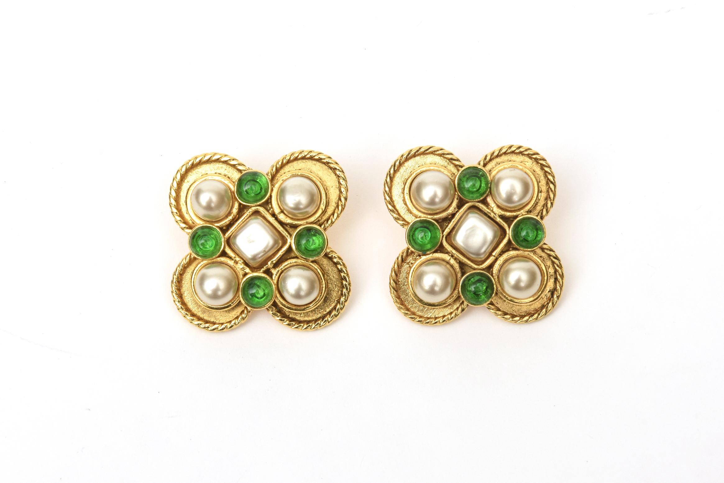 These stunning pair of Chanel Gripoix green glass and faux pearl clip on earrings are from the 90's. They have a stately look on the ear lobe. The twisted gold metal in rope design accents the colors and materials. These can go day to evening and
