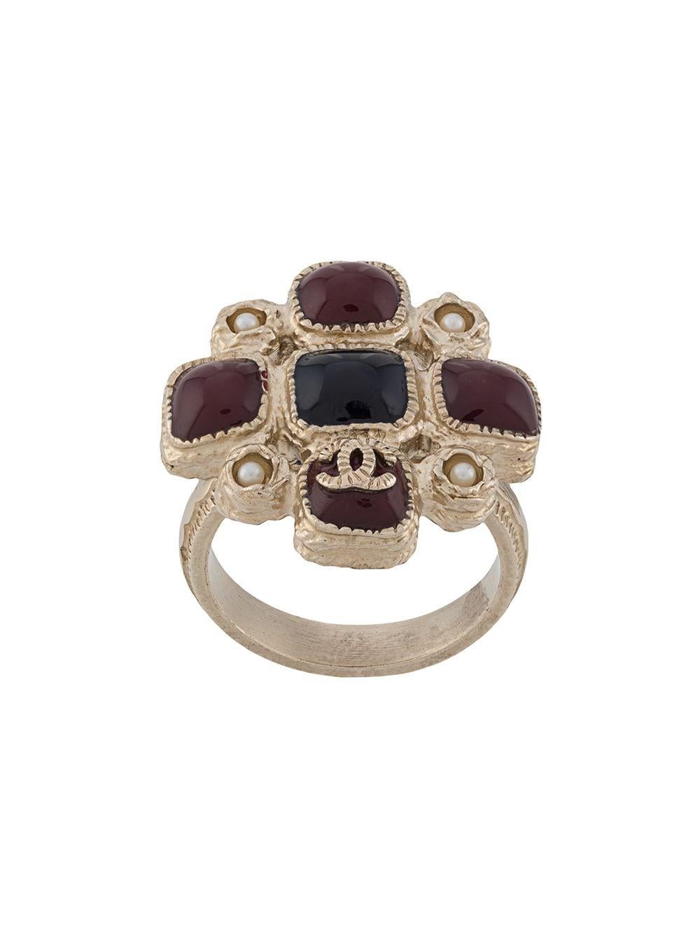 Crafted in France from gold-plated metal, this ornate vintage ring from Chanel showcases a regal maltese cross design, an embossed finish and an easy slip-on style. For an added touch of classic sophistication, this statement accessory is adorned by