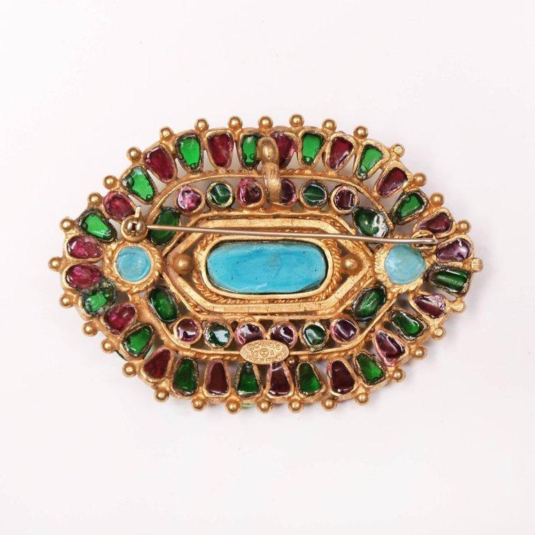 A rare Chanel brooch which has multi color Gripoix glass stones and pate de verre set in a matte gold open work pattern. There is also a hook so it can be worn as a necklace .
A stunning piece of Chanel collectable jewellery.
