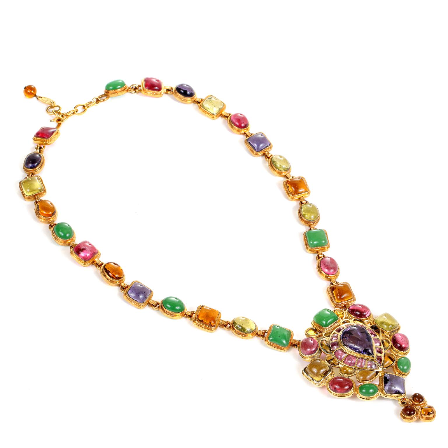 This authentic Chanel Gripoix Multicolor Drop Necklace is in excellent vintage condition from the mid 1980’s.  
Pink, purple, orange, yellow and green oval and square Gripoix glass stones are set in gold tone metal.   Dramatic multihued Gripoix