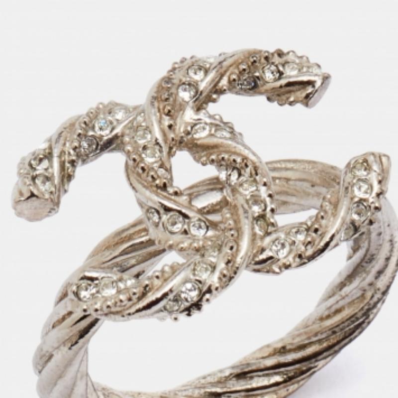 Dieser Ring von Chanel ist der Inbegriff von Luxus! Sie ist liebevoll aus Metall gefertigt und besteht aus einem gedrehten Band, das mit dem kultigen CC-Logo endet. Er ist mit Kristallen bestreut.