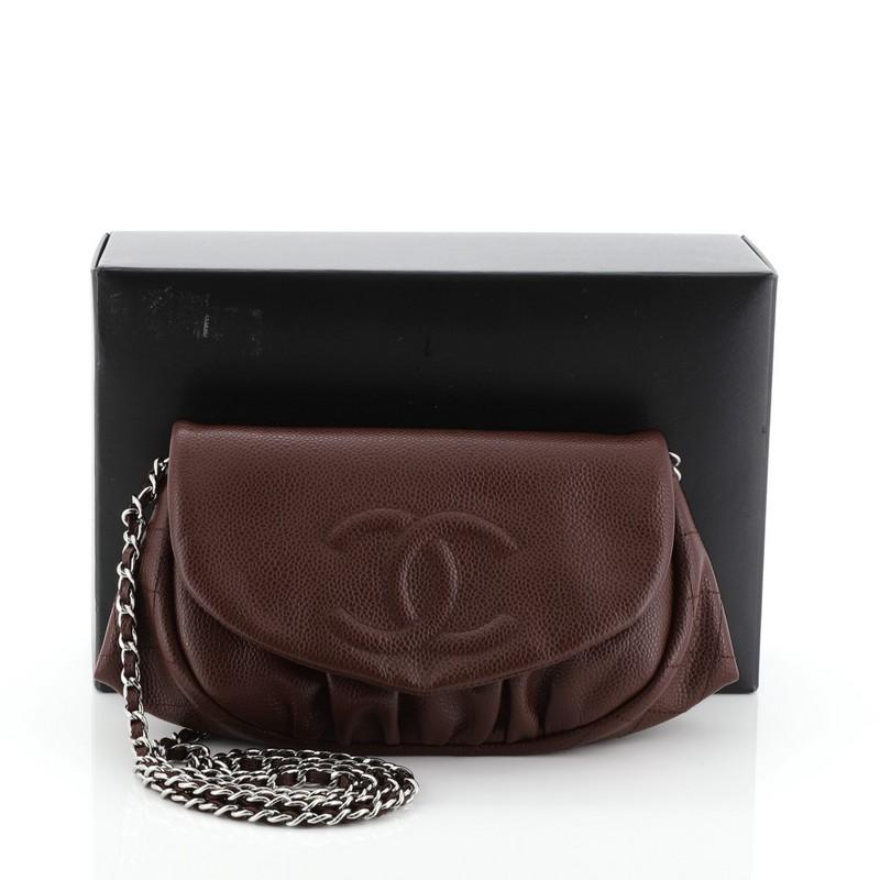 This Chanel Half Moon Wallet on Chain Caviar, crafted in red caviar leather, features woven-in leather chain strap, moon shape structure, pleated design under its flap, and silver-tone hardware. Its magnetic closure opens to a gray fabric interior