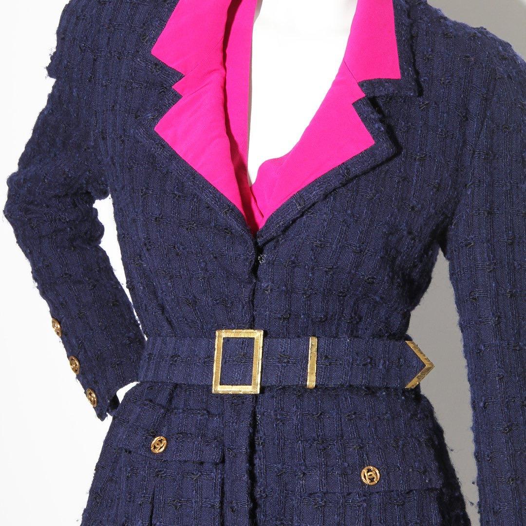 Product Details:
Haute couture tweed 3 piece suit by Chanel
Circa early 1970's
Blue tweed suit  
Pink Lapel 
Two front pockets on jacket
Waist belt
Hook and eye front closure on jacket
Gold tone hardware 
Button cuff closure 
CC logo buttons