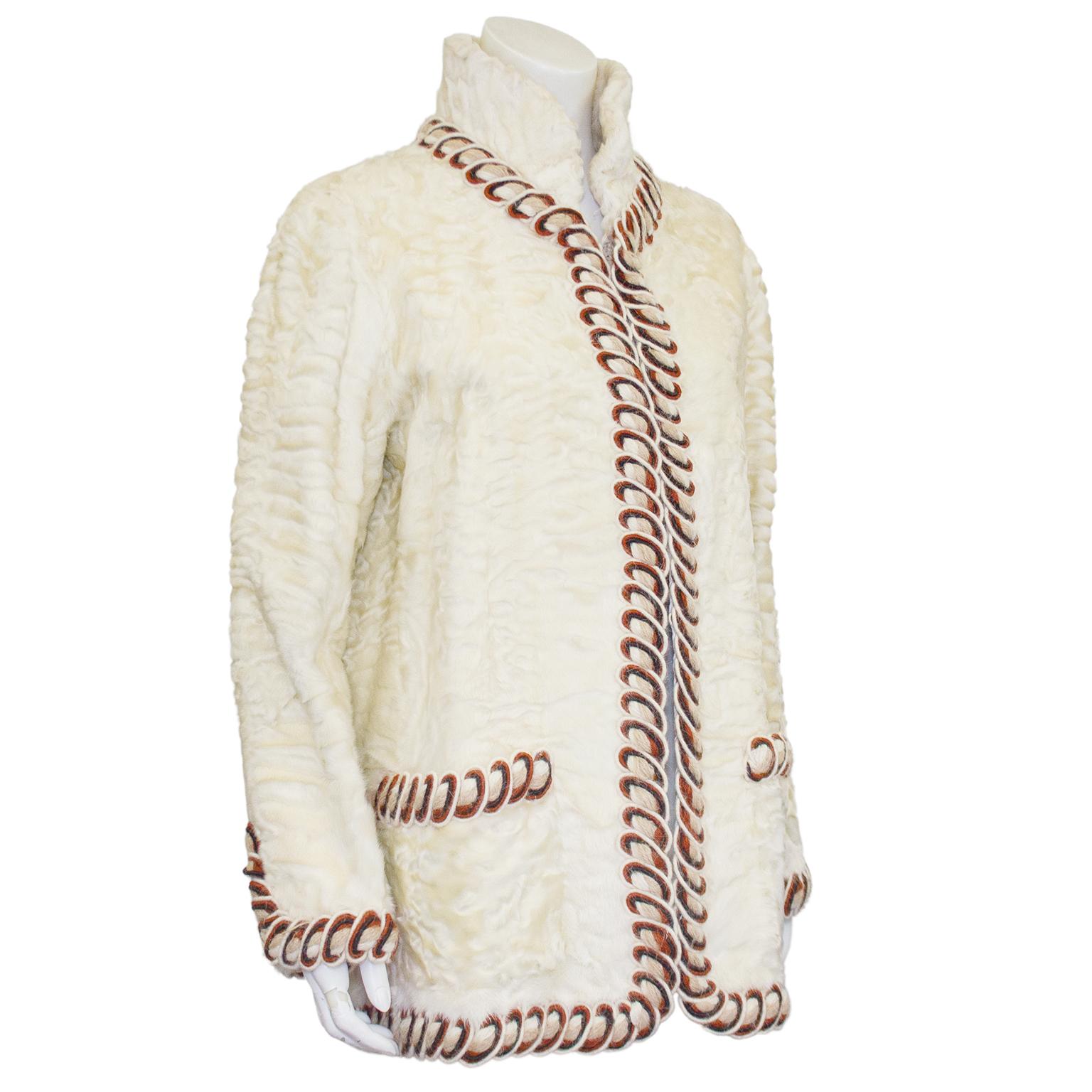 1980's Chanel Haute Couture off-white Persian Lamb jacket trimmed in burgundy and cream passementerie. High mandarin style collar can be worn fully extended or turned down for a less formal look. Provenance from a well known American 1950's cabaret