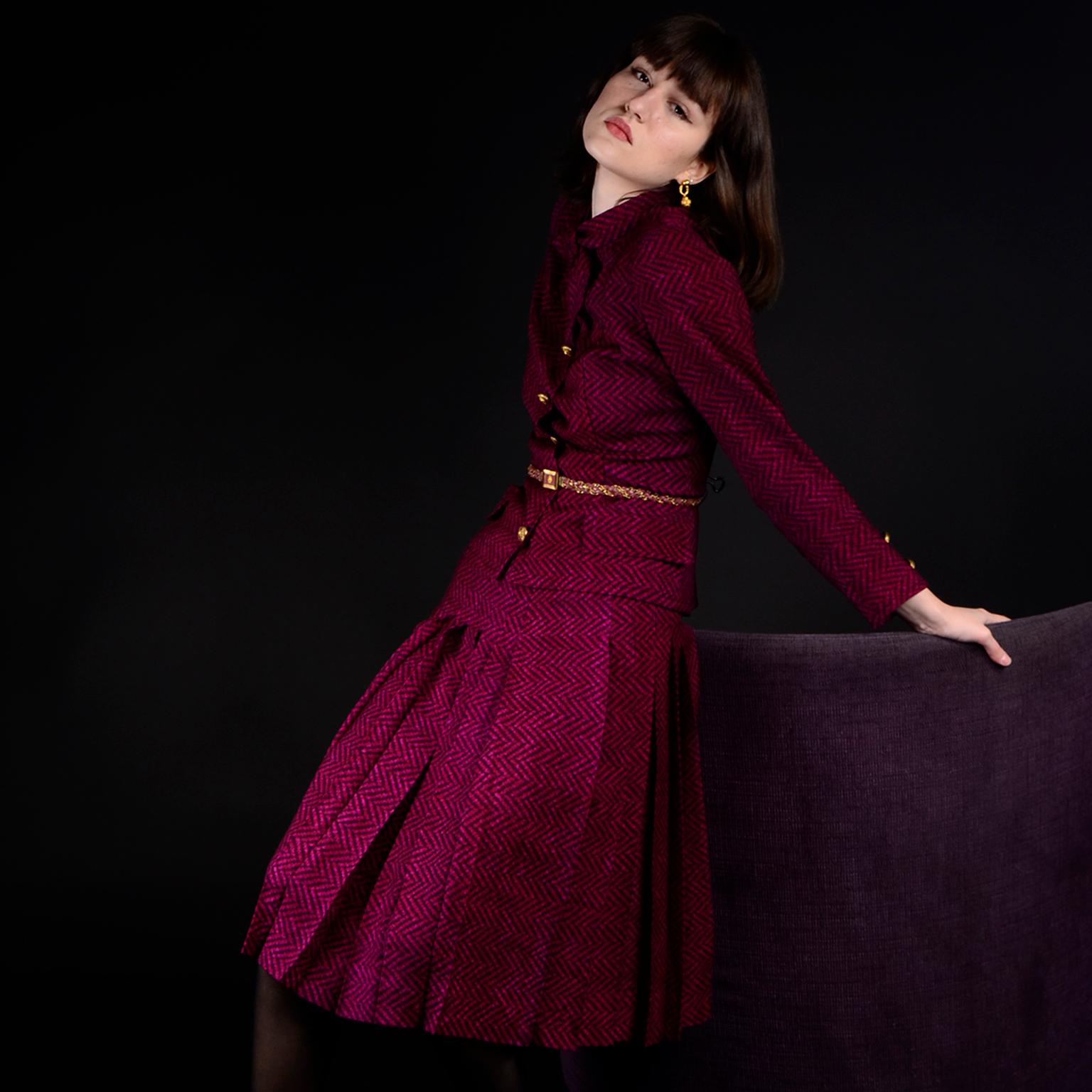 This outstanding vintage celebrity owned Chanel Couture jacket top and skirt suit is in a sublime magenta and plum purple chevron lightweight wool challis with a braided leather belt. Though this is technically a suit, it feels more like a blouse