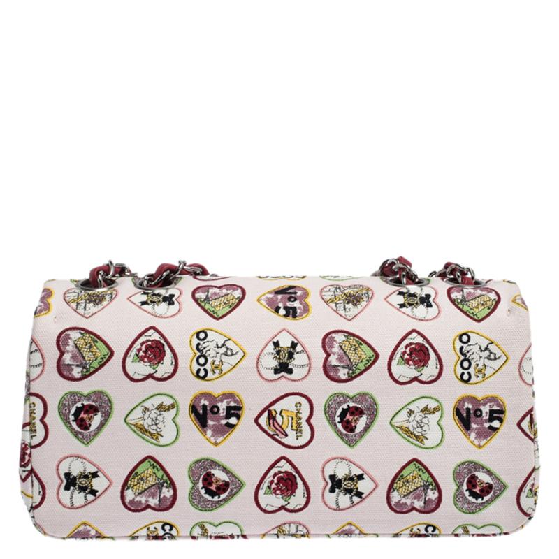 We are in utter awe of this flap bag from Chanel as it is appealing in a surreal way. Exquisitely crafted from multicolored heart-printed canvas, it bears their signature label on the fabric interior and the iconic CC turn-lock on the flap. The