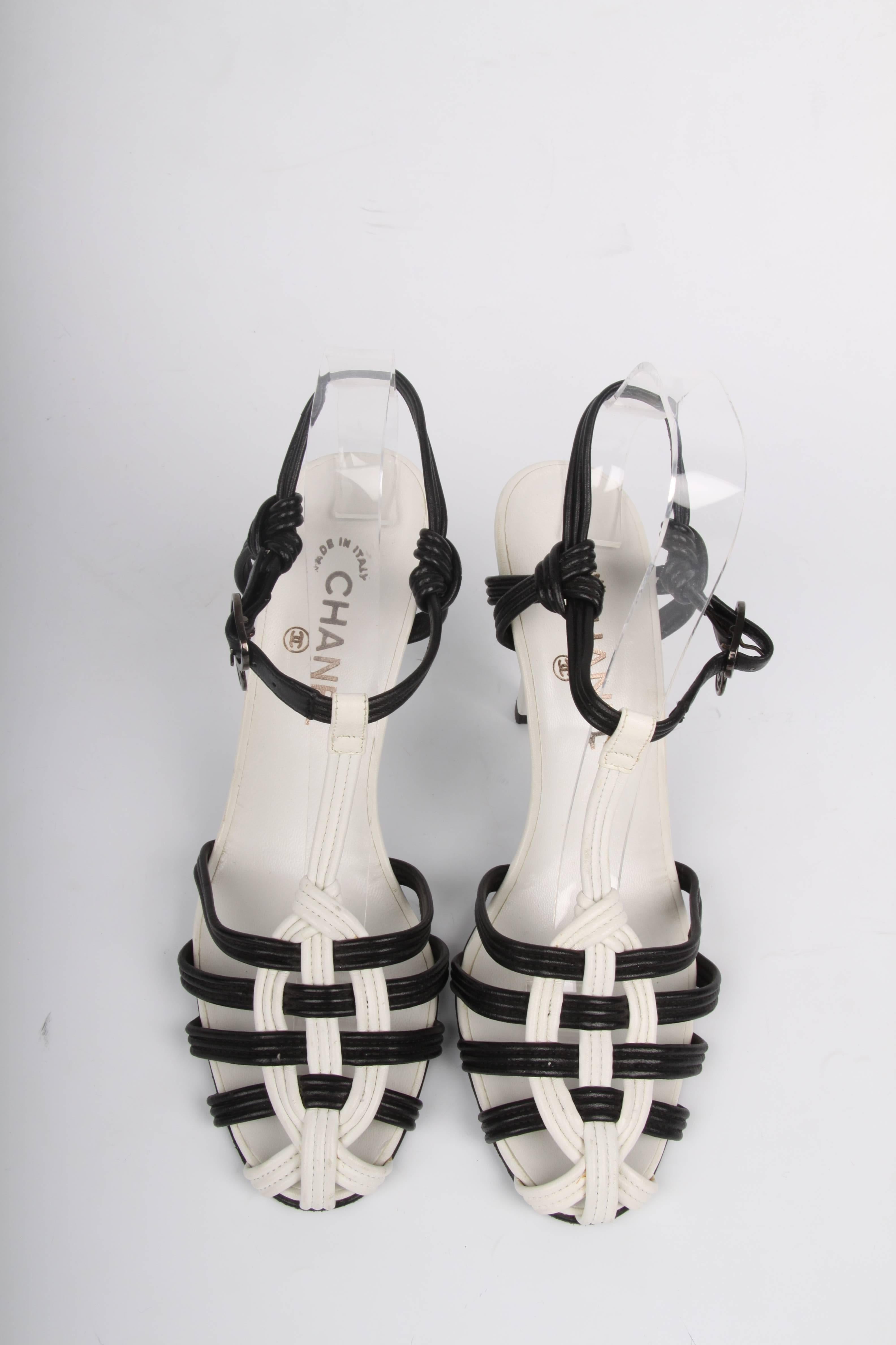 Black and white is always chic! Look at these high heeled sandals by Chanel.

A striped heel that measures 11 centimeters, no platform. Narrow white straps on the instep and a vertical black patent leather patch. A long strap to tie around the