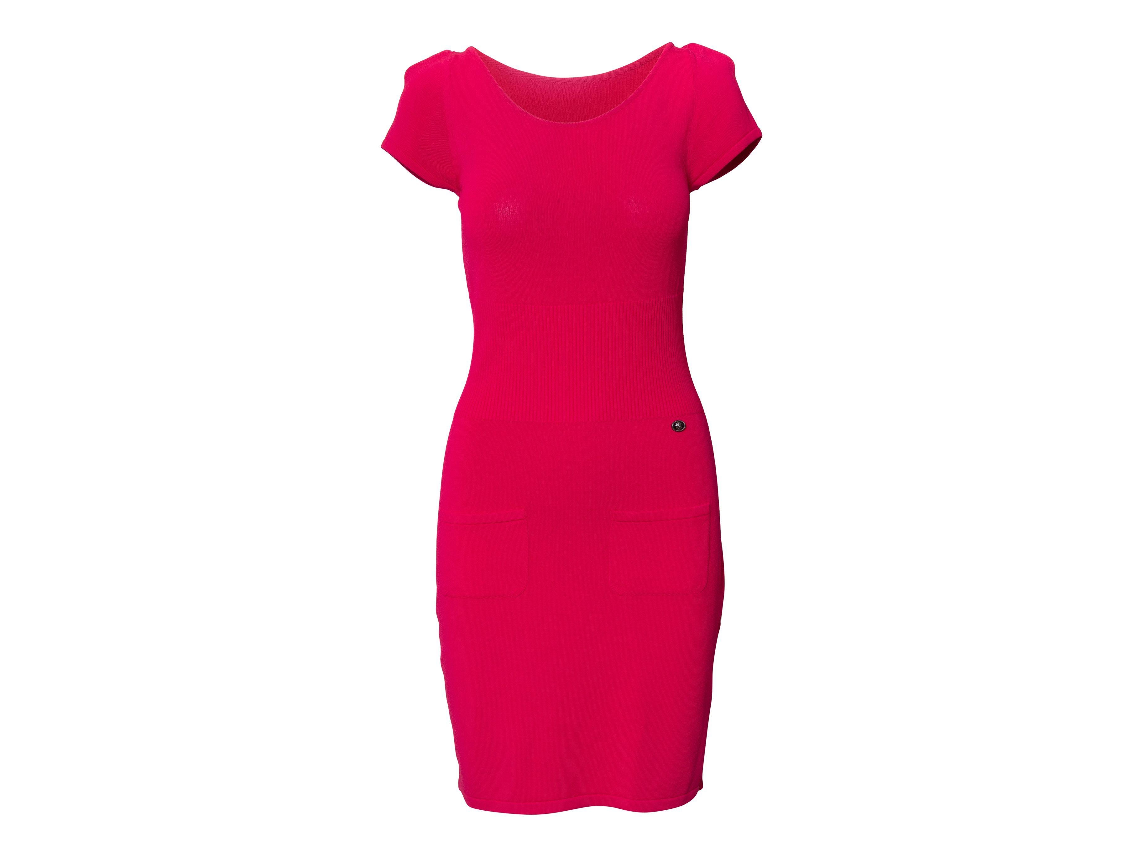 Product Details: Hot pink knit cap sleeve mini dress by Chanel. Round neckline. Dual pocket details at front. 28