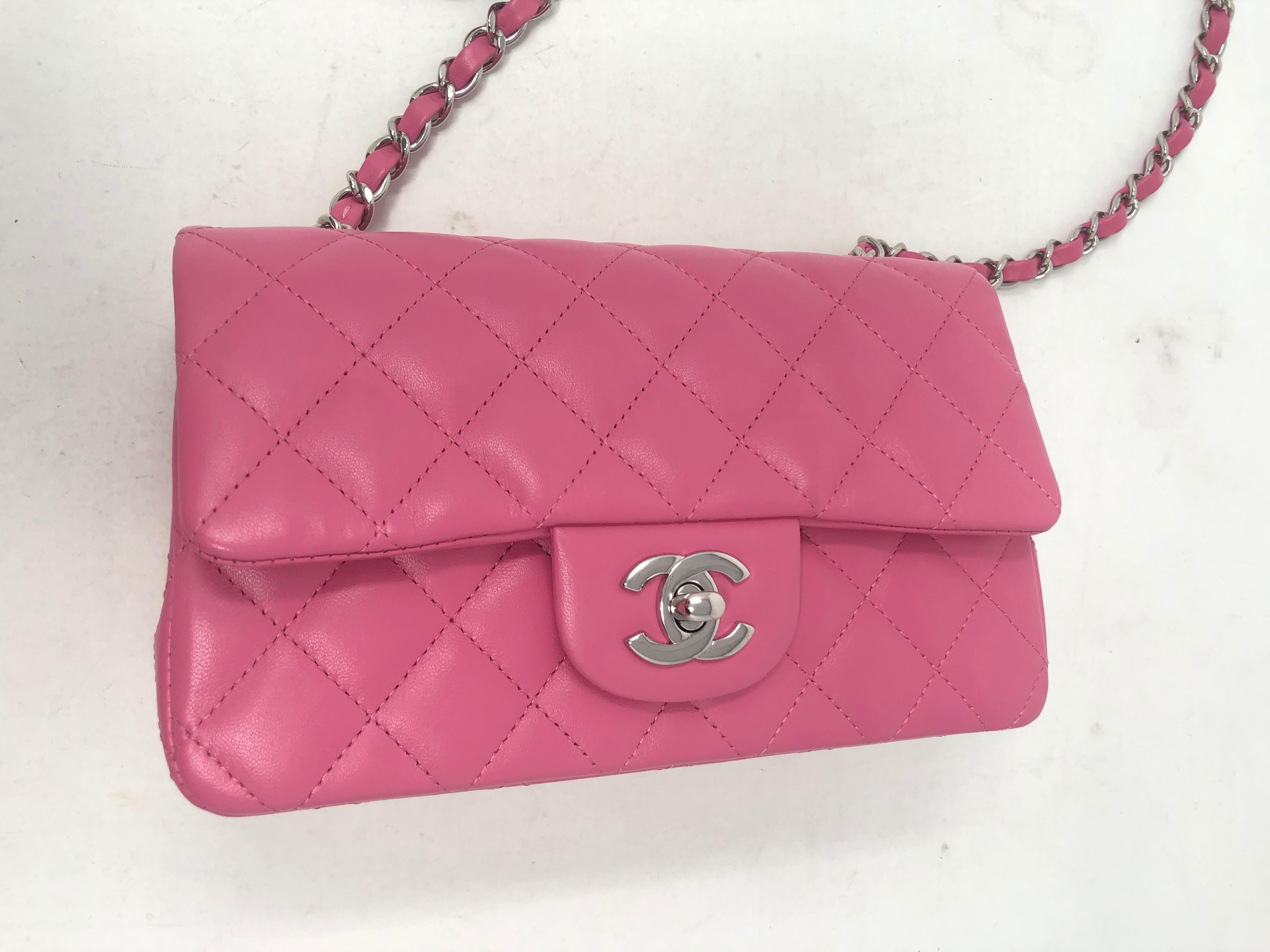 Chanel Hot Pink Lambskin Mini Crossbody Bag. Mint like brand new condition. Fun pop of bubblegum pink color. Silver hardware. Rare color and size. Mini bags are the rage. Collector's piece. Authenticity card included with Chanel dust cover.