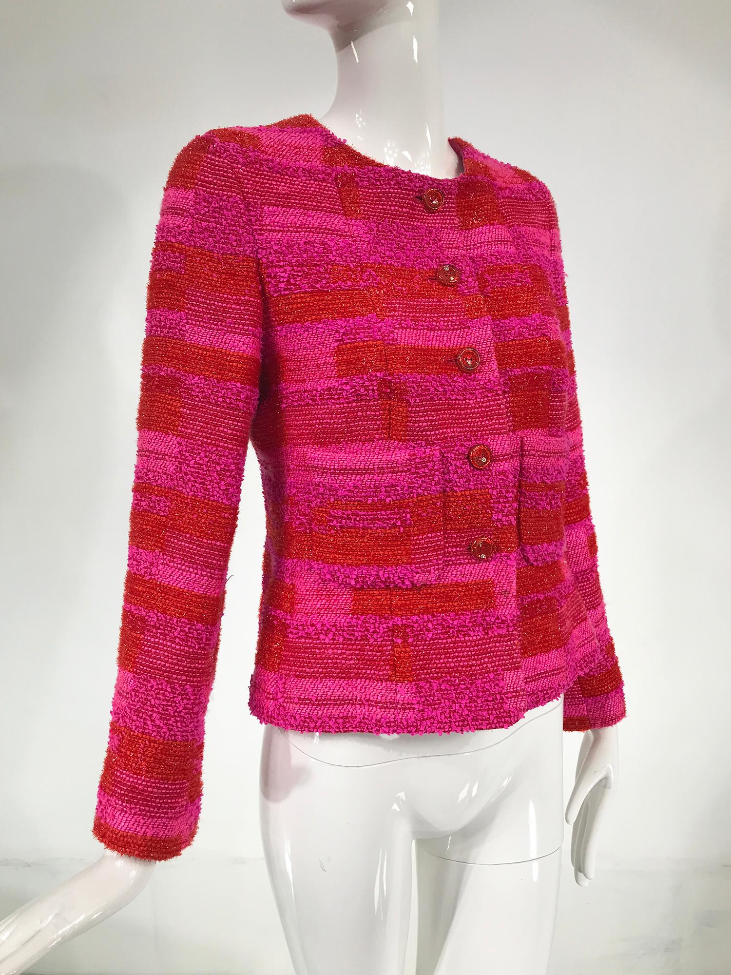 Chanel hot pink, orange and gold metallic thread cropped jacket 2001C.
Jewel neck jacket closes at the front with pink acrylic signed in gold Chanel buttons. Hip bone length with long sleeves that have cuff vents. Lined in pink silk satin with a