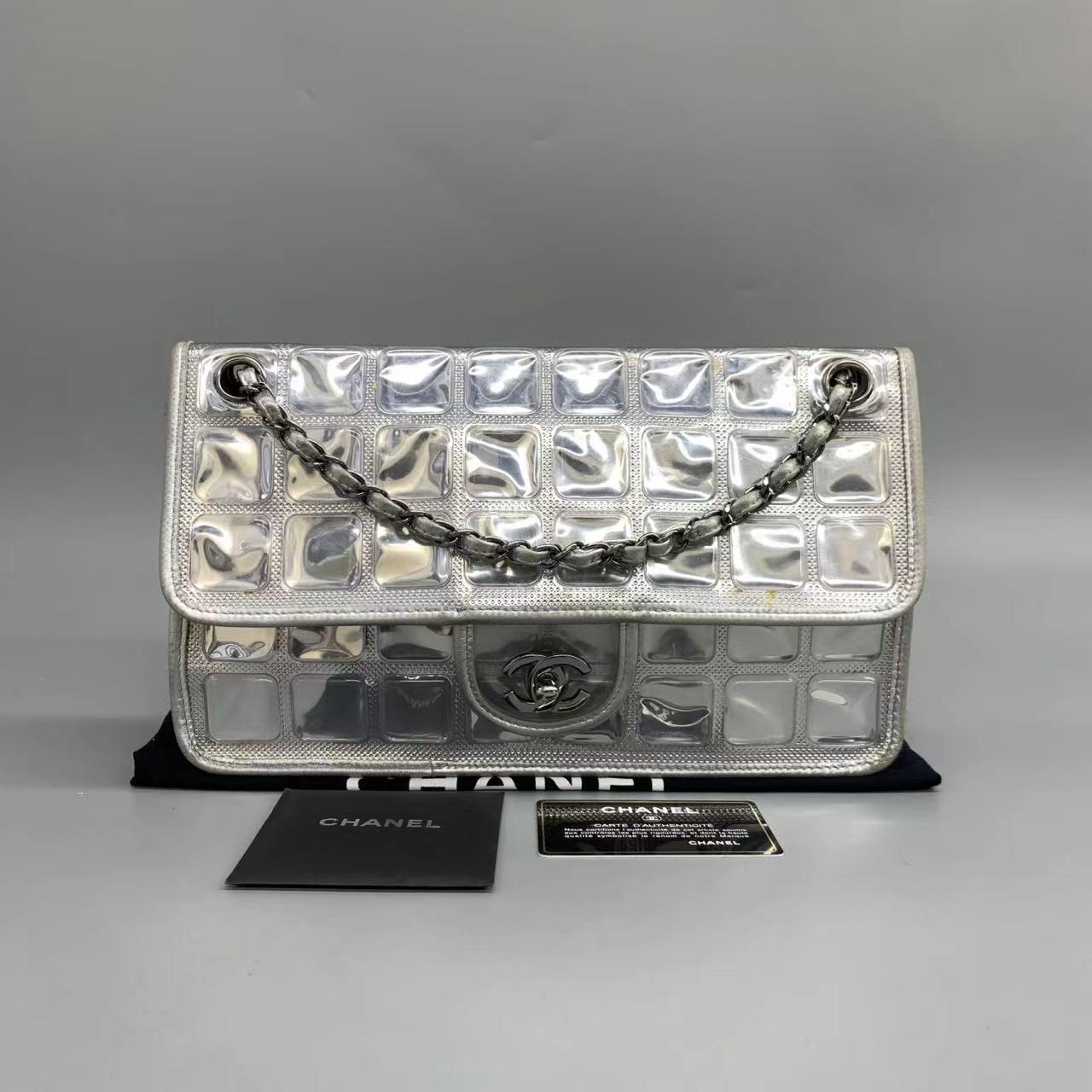 This charming collectible and highly sought after Chanel Ice Cube 2006-2008 is a stylish mix of classy and casual. Featuring a chain and leather strap, foldover top with twist-lock closure, and a square quilted finish, this bag is crafted from