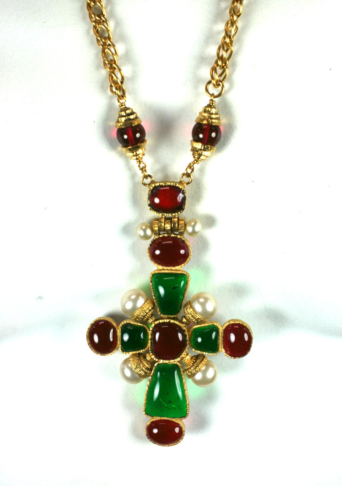 Iconic cross necklace by Karl Lagerfeld for Chanel. Emerald and Ruby poured glass are mixed with handmade  faux pearls for this Renaissance style cross. A heavy gilt rolo chain is spaced with ruby beads. Made by the Maison Gripoix studio in Paris.