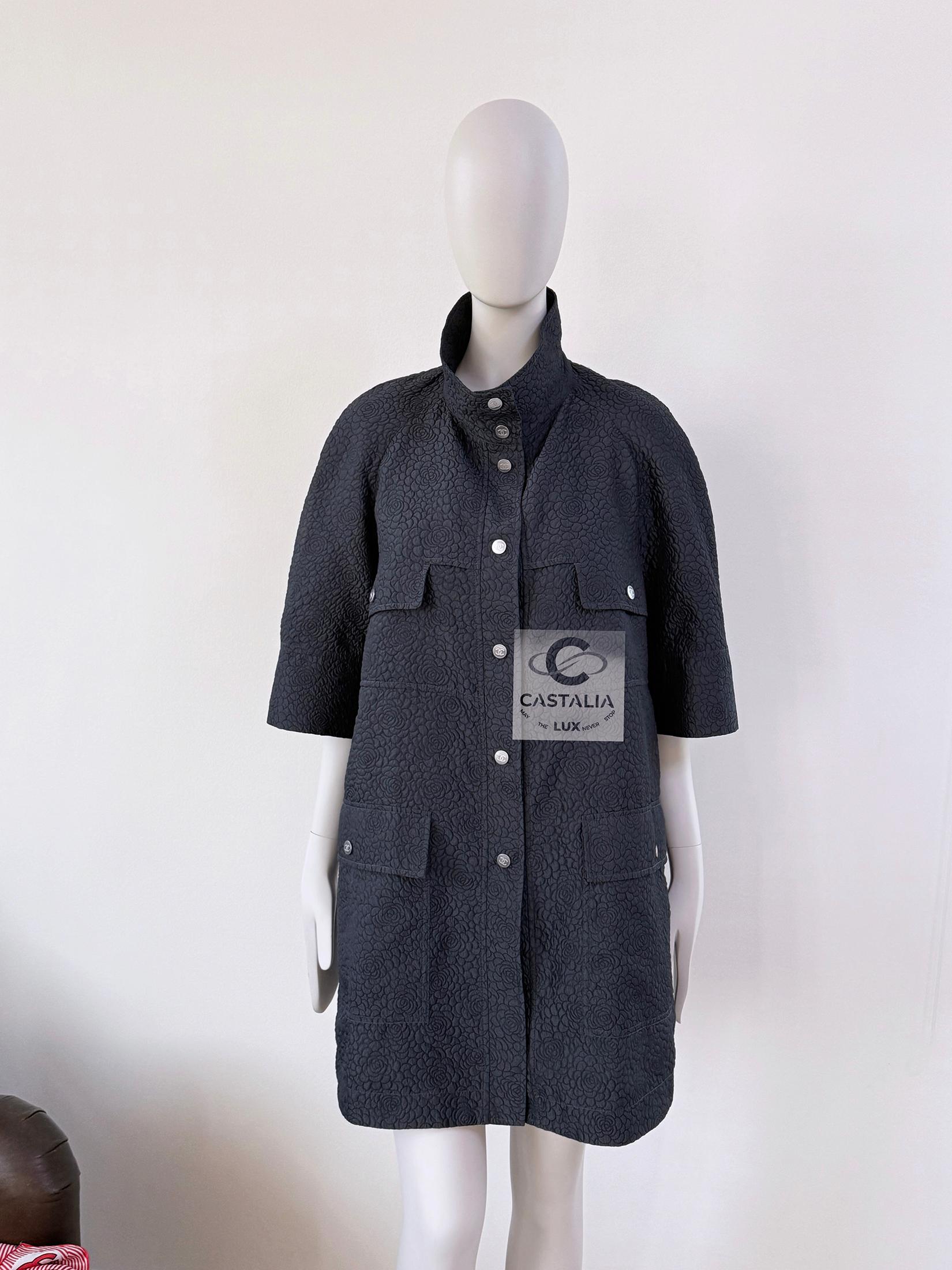 Iconic Chanel black / anthracite trench coat with Camellias 3-d pattern ~ featuring brand's most recognisable cocoon silhouette!
- CC logo buttons at front, pockets and cuffs
- contrast lining
Size mark 44 FR / Condition: never worn