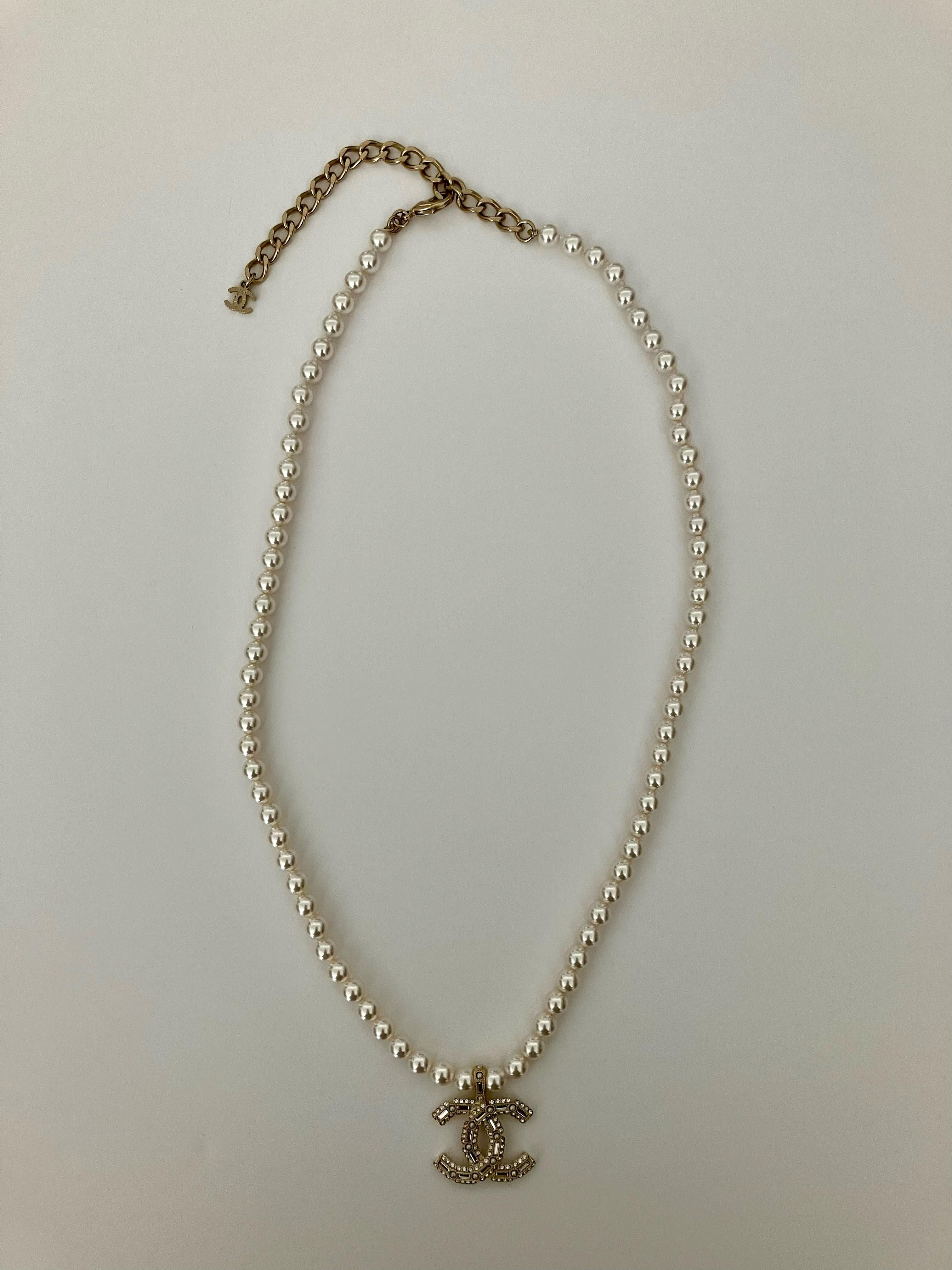 Chanel gold-tone and faux-pearls necklace featuring spring-ring fastening with Chanel pitted on, a front logo with strass and beads, faux-pearls beads. 
Maxi Length: 
Front Chanel medal: 1in (2.5cm) X 1in (2.5cm)
Circa: 2000s
In excellent vintage
