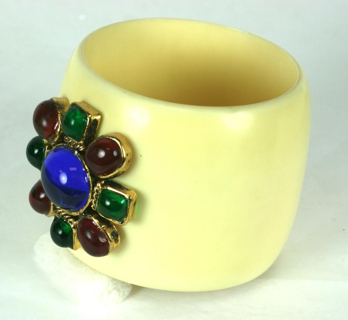 Chanel ivory resin cuff bracelet by Karl Lagerfeld, inspired by the original Maltese Cross Cuffs that Verdura designed for Chanel in the 1930s decorated with a ruby, emerald and sapphire poured glass enamel crest by Maison Gripoix. 
The jeweled cuff