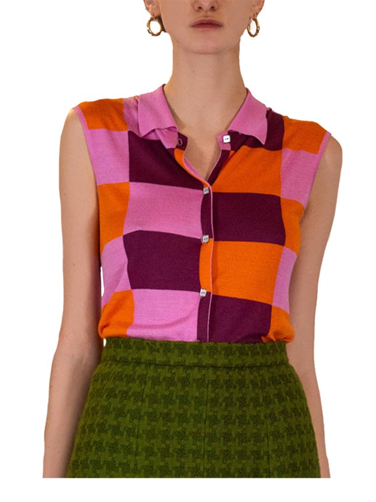 Chanel finely knitted sleeveless polo shirt in a pink aubergine and orange geometric design. Completed with square mother of pearl buttons bearing the House script.

Chanel Identification label. Circa 2000. 88% viscose, 12% silk. 38 marked