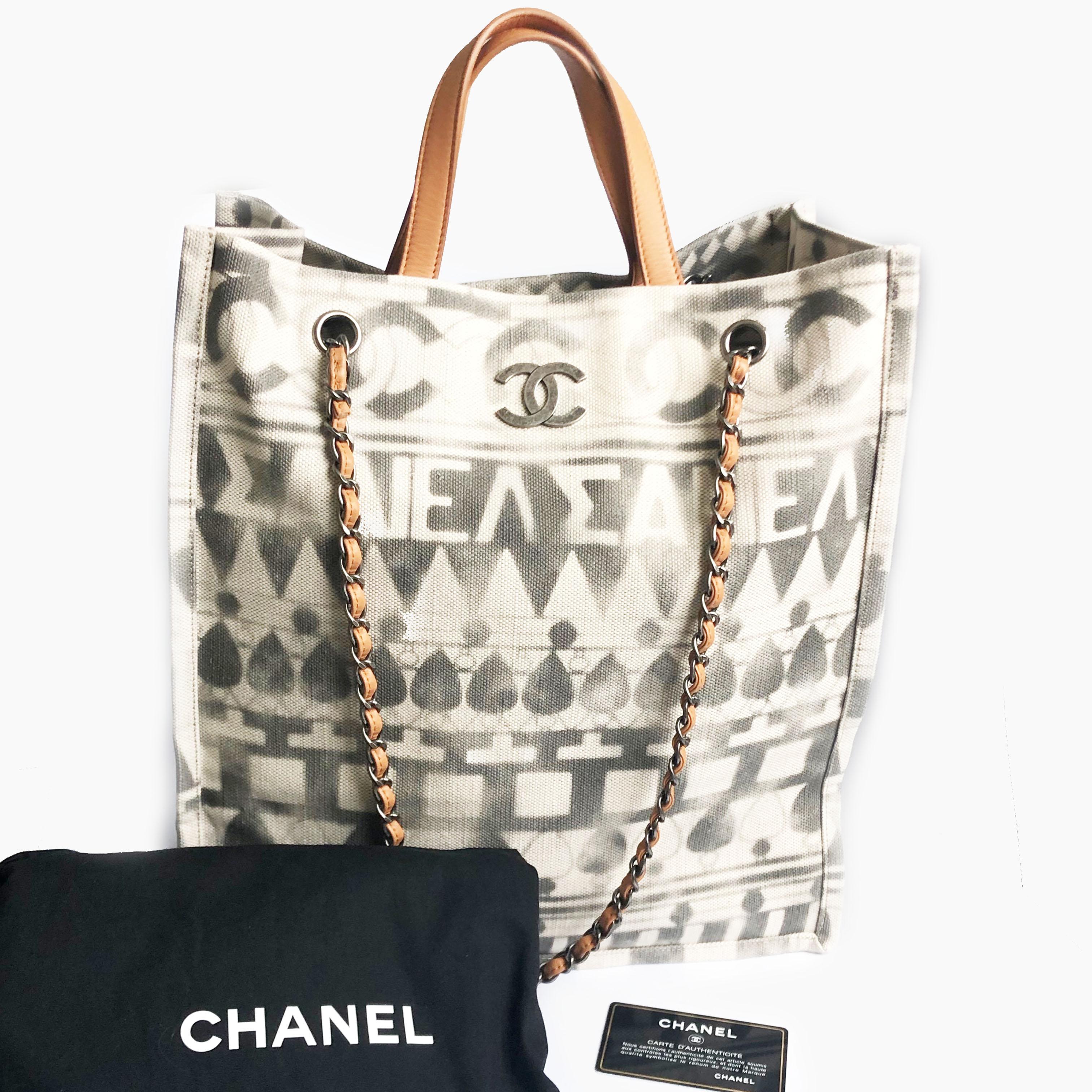Authentic, preowned Chanel Iliad Large Tote Bag from the 2018 Cruise Collection, featuring Greece antiquities and modernity.  Made from canvas with leather top handles and removable chain & leather shoulder straps.  Lined in beige canvas with one