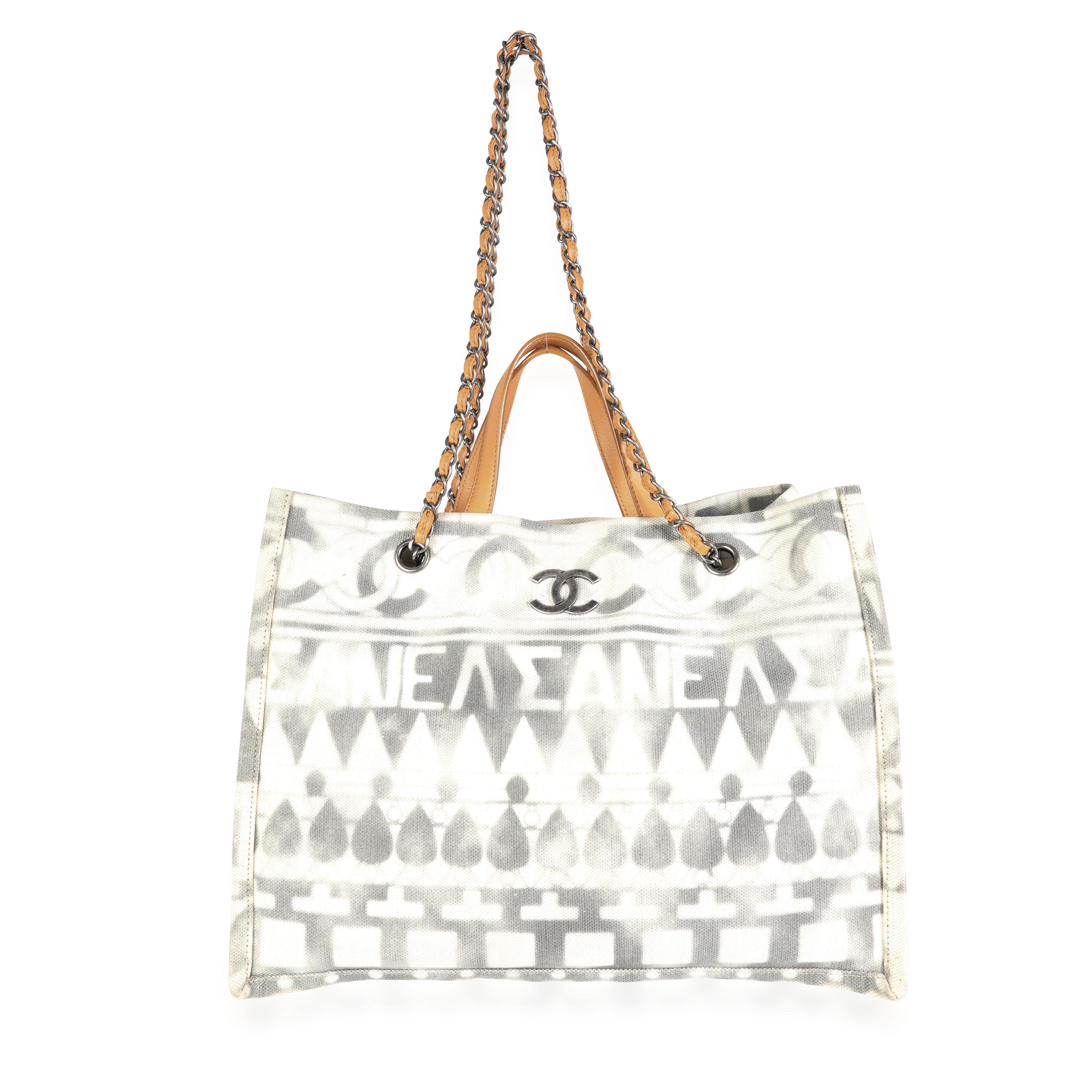 Listing Title: Chanel Iliad Printed Canvas Small Shopping Tote
SKU: 114880
Condition: Pre-owned (3000)
Condition Description: This gorgeous canvas Shopping Tote, created for Chanel's Greece inspired Cruise 2018 Collection, features a faded 'Iliad'