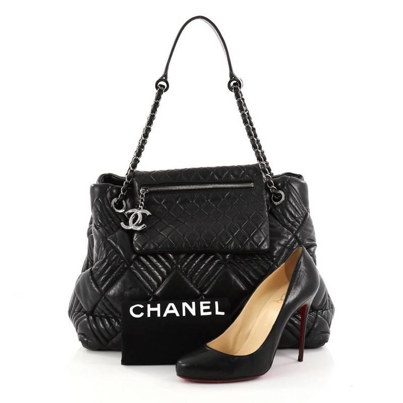 This authentic Chanel In and Out Flap Tote Quilted Lambskin Large is a classic piece from Chanel's 2008 Collection. Crafted from black lambskin leather, this luxurious flap tote features diamond quilted design in alternating diagonal stripes, unique