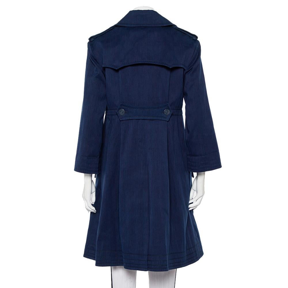 A Chanel coat to wear and treasure for years is this one in indigo blue. It is made from cotton and designed in a double-breasted style. The coat is not just well-tailored or appealing, it is also lightweight and comfortable.

