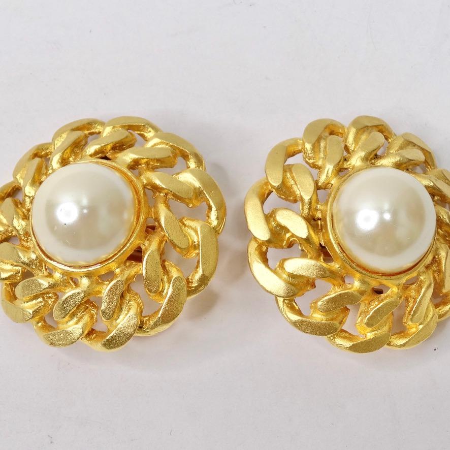 These 1980s 14K gold plated clip on earrings are so classic and chic! Gorgeous jumbo statement earrings feature beautiful 14K yellow gold plated chain motifs surrounding a large faux pearl at the center to create a design very reminiscent of a