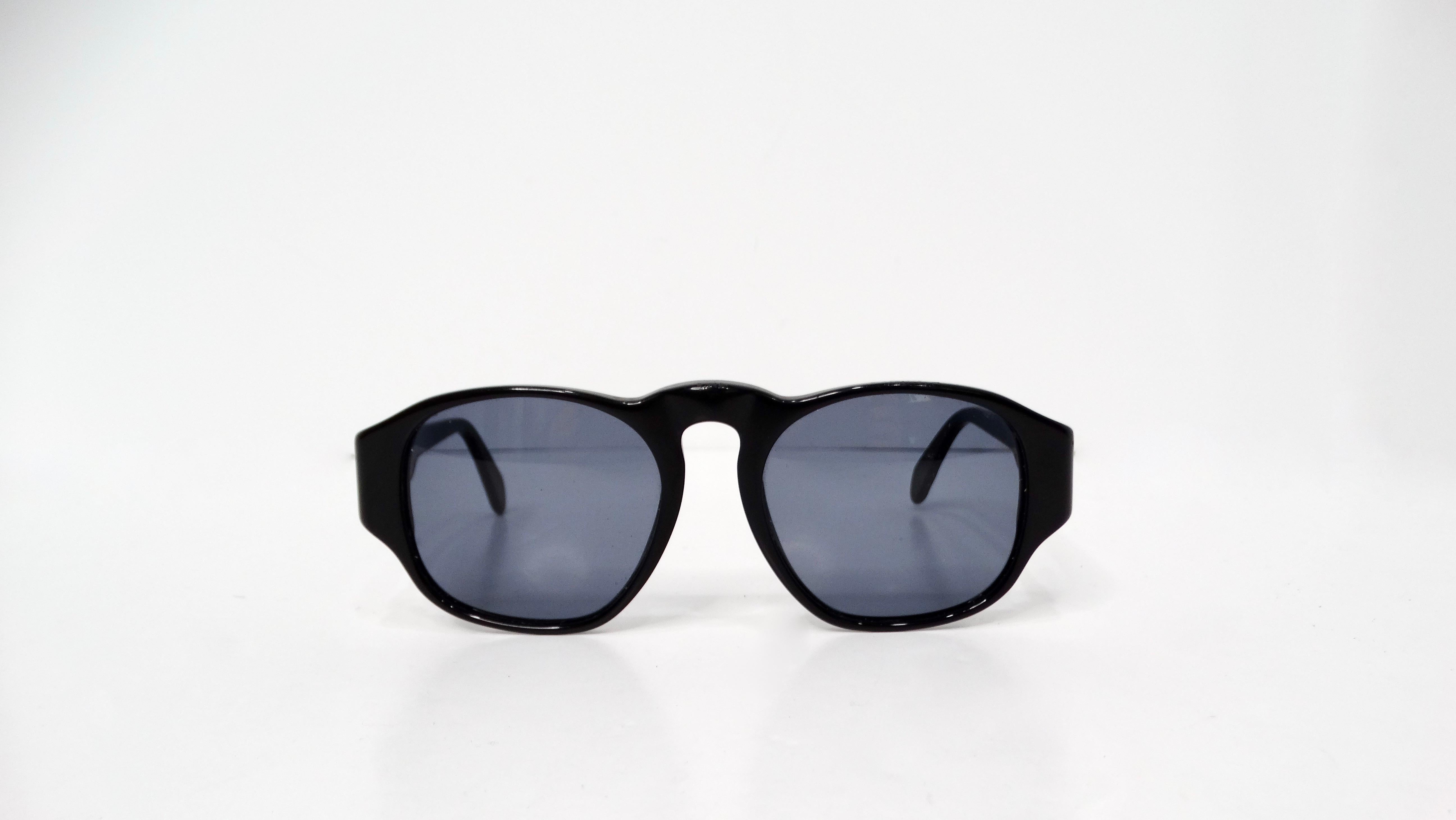 The Y2K Chanel Interlocking CC Black Square Framed Sunglasses are a chic and timeless accessory that perfectly captures the essence of early 2000s glamour with a modern twist. Crafted with sleek black square frames, these sunglasses exude