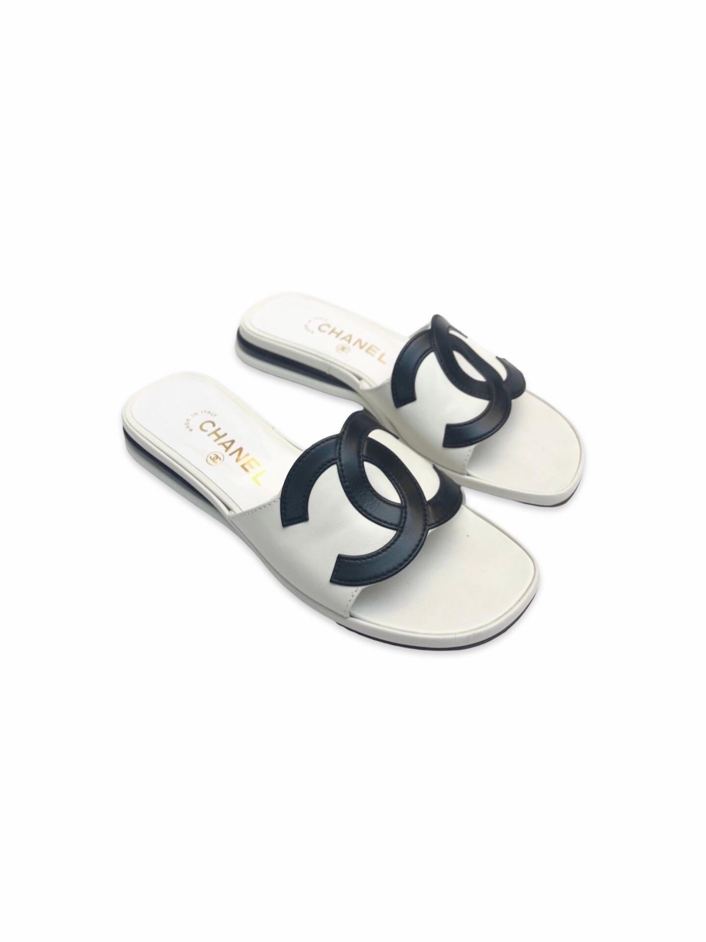- Rare Chanel black and white leather sandals from the 90's  collection. Featuring a big black interlocking CC logo. 

- Featuring two white and two black layers leather soles  Craftsmanship is on point with a futuristic vibe and smooth shape from