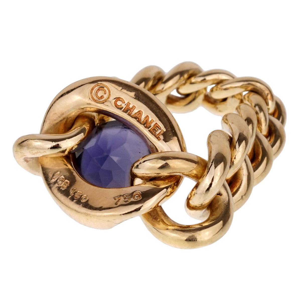 A fabulous Chanel ring with graduated chain links in 18k yellow gold showcasing a cabochon cut Iolite. The ring measures a size 6 1/2