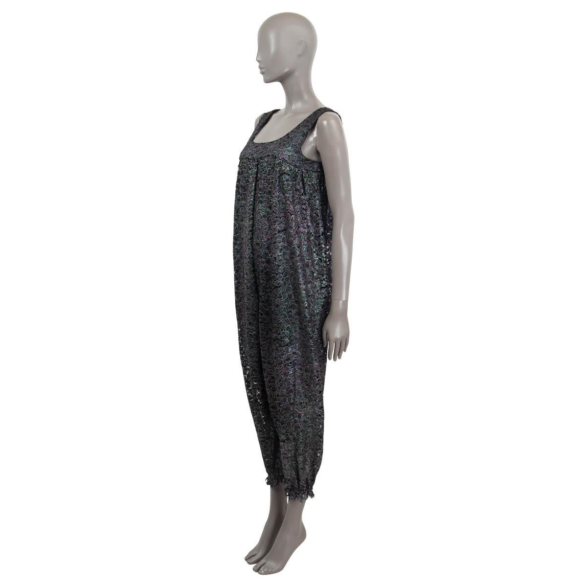 100% authentic Chanel iridescent drop crotch jumpsuit in petrol, purple, gray and black silk and elastane (assumed cause tag is missing). Opens with a zipper and a hook on the back. Comes with a slip jumpsuit in gray silk (assumed cause tag is