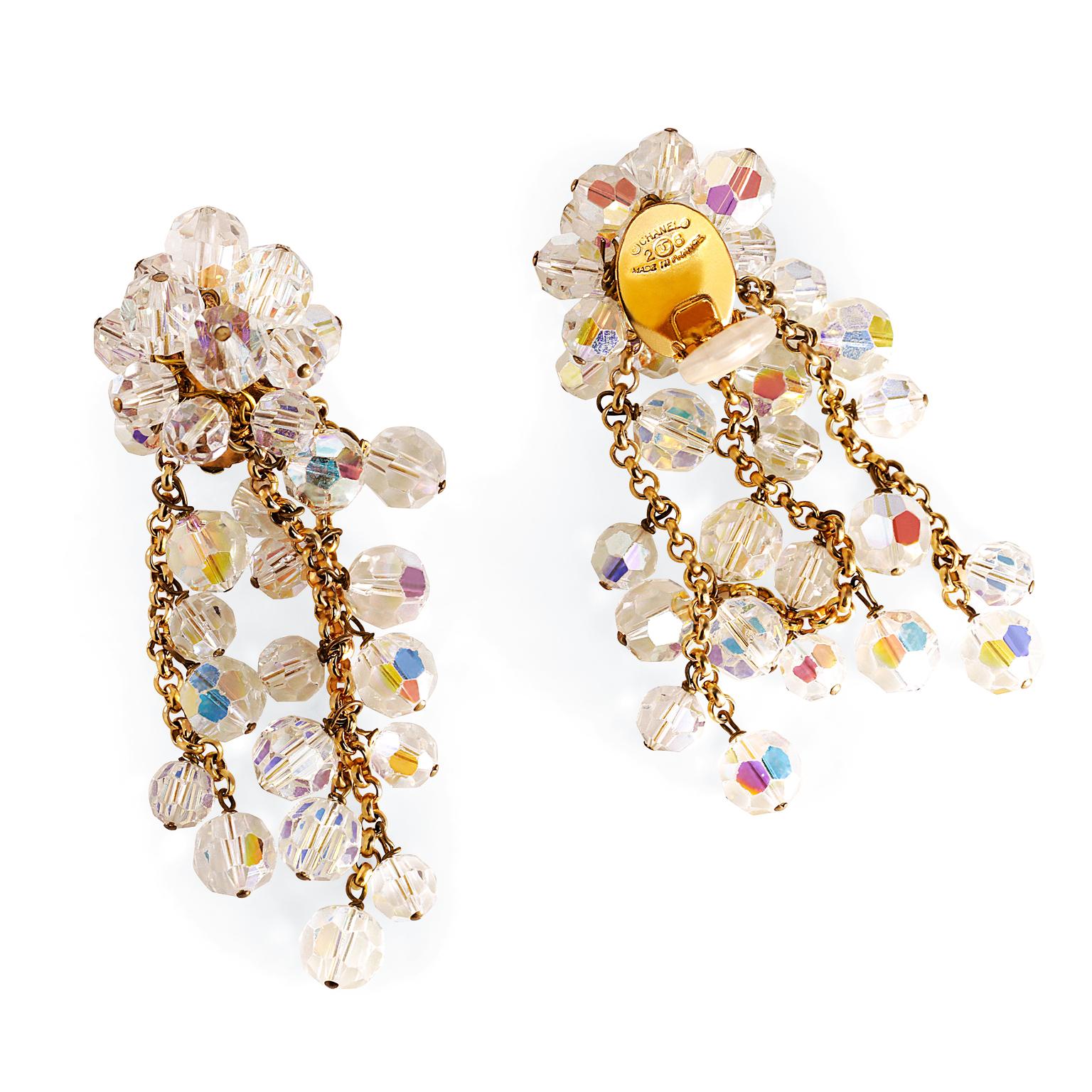 These authentic Chanel Iridescent Beaded Dangle Earrings are in excellent condition from the early 1990’s.  A beaded cluster supports multihued iridescent beads that dangle from gold tone chains.  Clip on closure.  Made in France.  Pouch or box