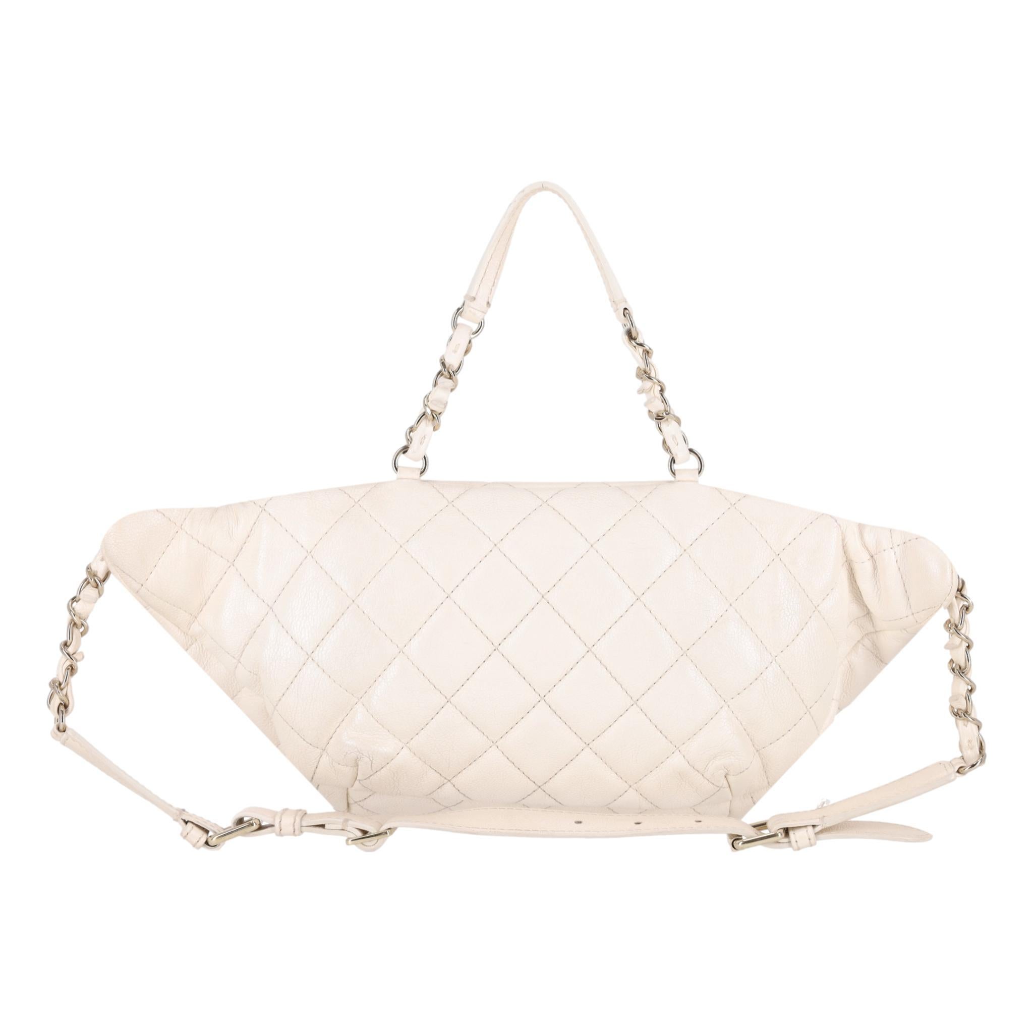 Chanel Iridescent Leather All About Waist Belt Bag

Off-white bag crafted in iridescent calfskin diamond quilted leather and designed with woven-in leather chain link and adjustable leather waist strap.

Featuring exterior zip pockets, gold hardware
