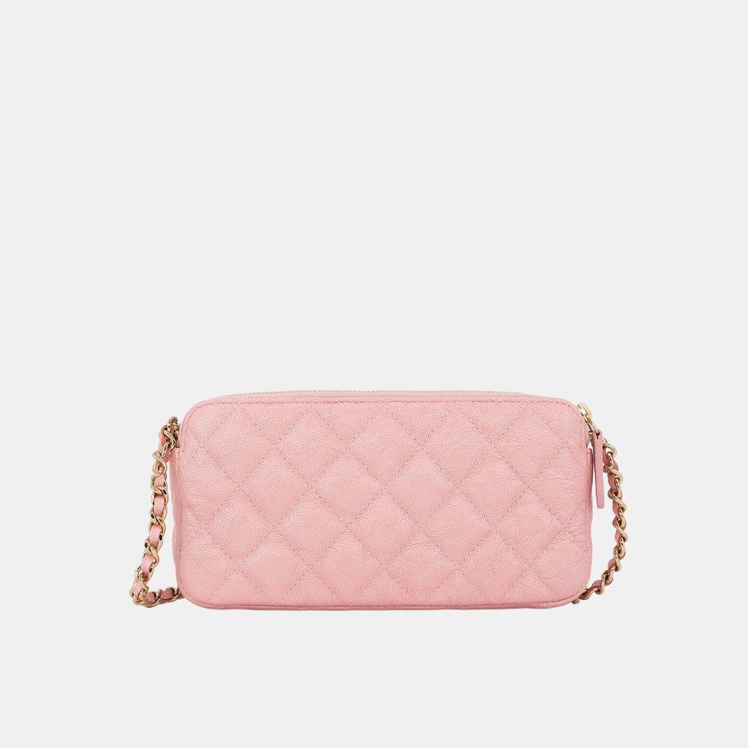 This Chanel Wallet on a Chain is the embodiment of playful elegance. Luxuriously created from cotton-candy pink lambskin leather, this versatile and timeless piece features the brand's signature diamond quilting, double zip closure, and chain