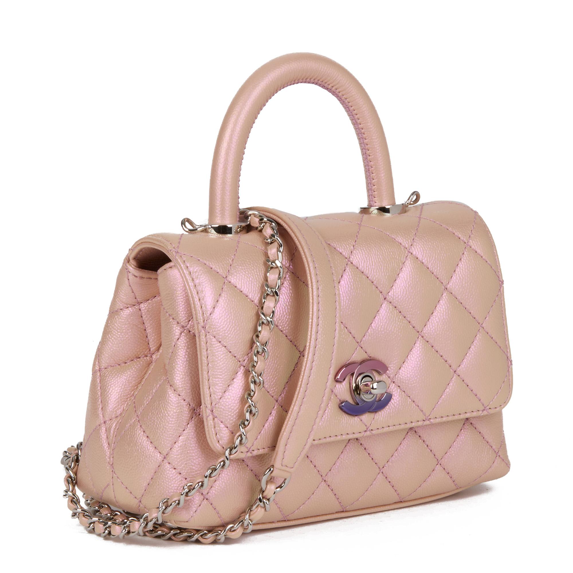 CHANEL
Iridescent Pink Quilted Caviar Leather Mini Coco Top Handle

Serial Number: UTKTHPE6
Age (Circa): 2021
Accompanied By: Chanel Dust Bag, Box, Protective Felt
Authenticity Details: Microchip (Made in Italy)
Gender: Ladies
Type: Top Handle,